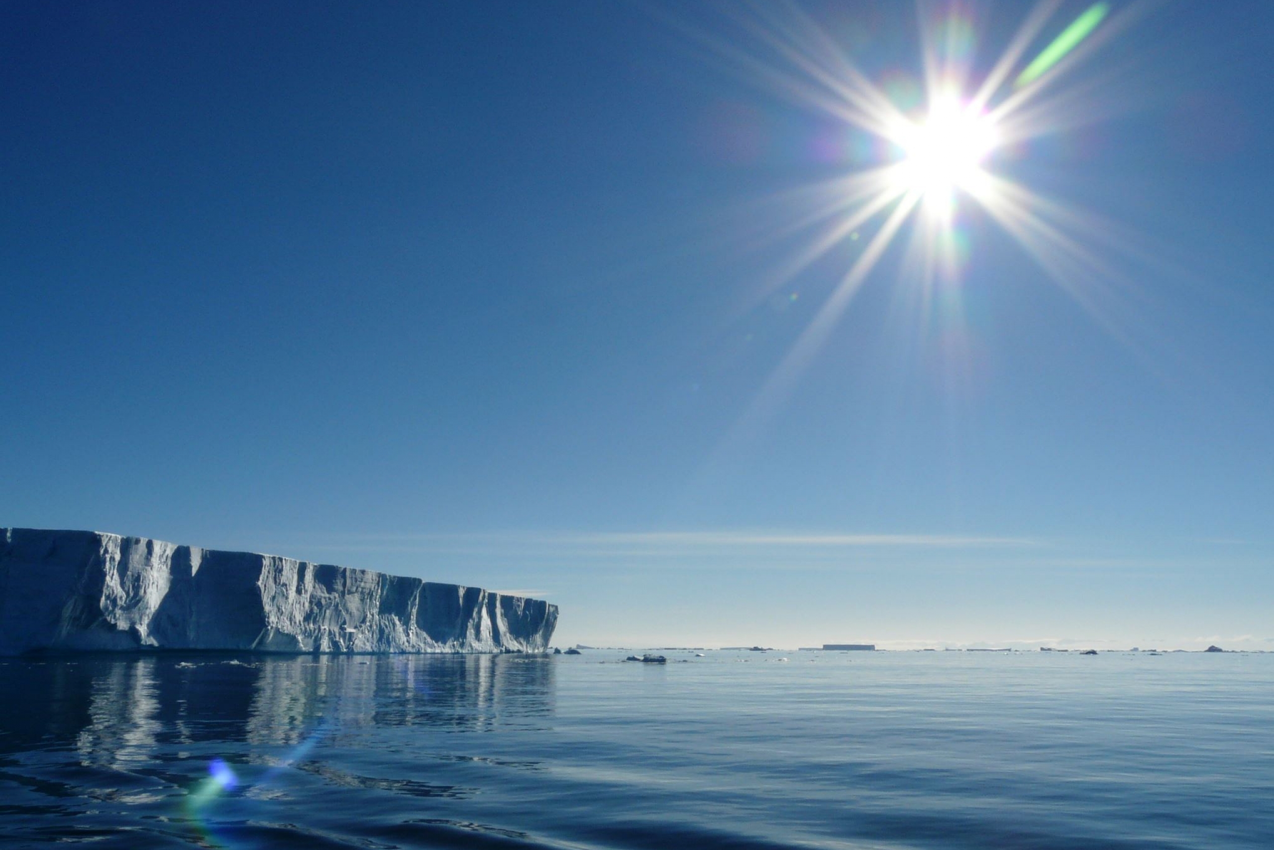 A large iceberg seen floating in a body of water.