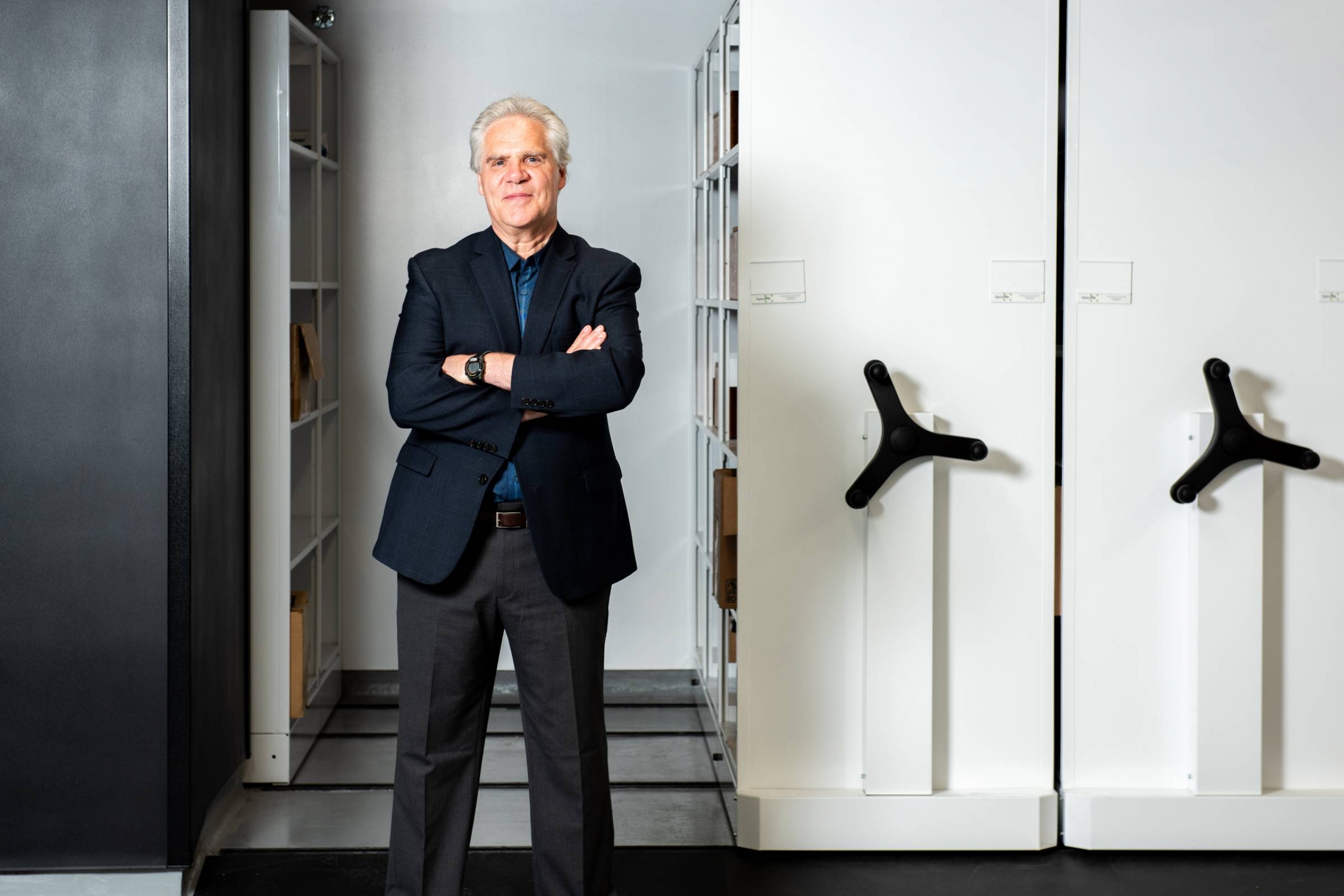 James Blanchard, Executive Director of UM's Institute of Global Public Health, stands next to a failing cabinet