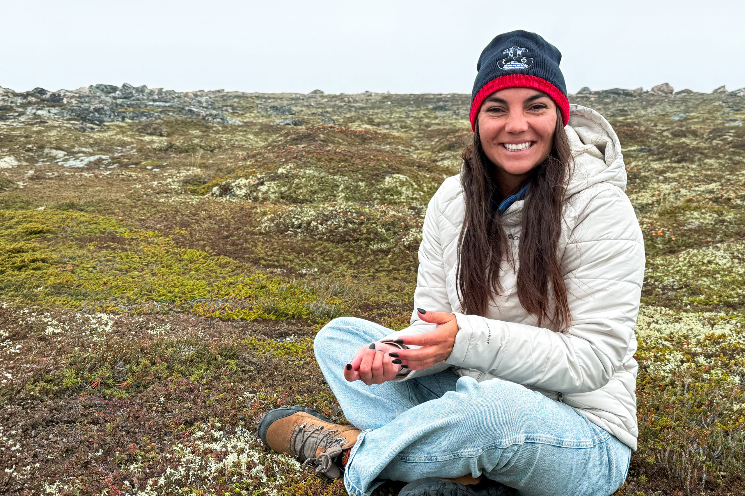 Doctoral student Jennifer Meixner picks berries in Nunavut