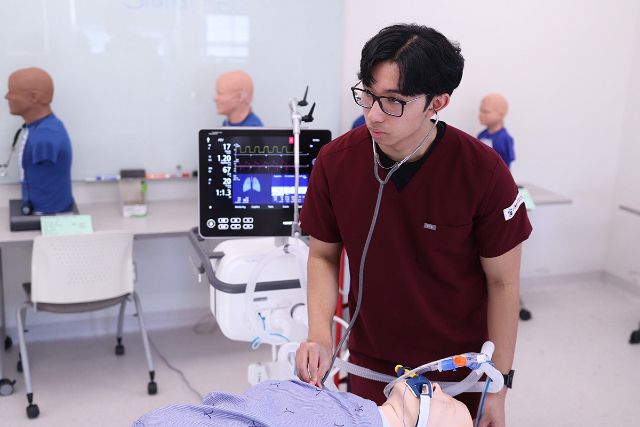 Jerick Dela Cruz working in a respiratory therapy lab.