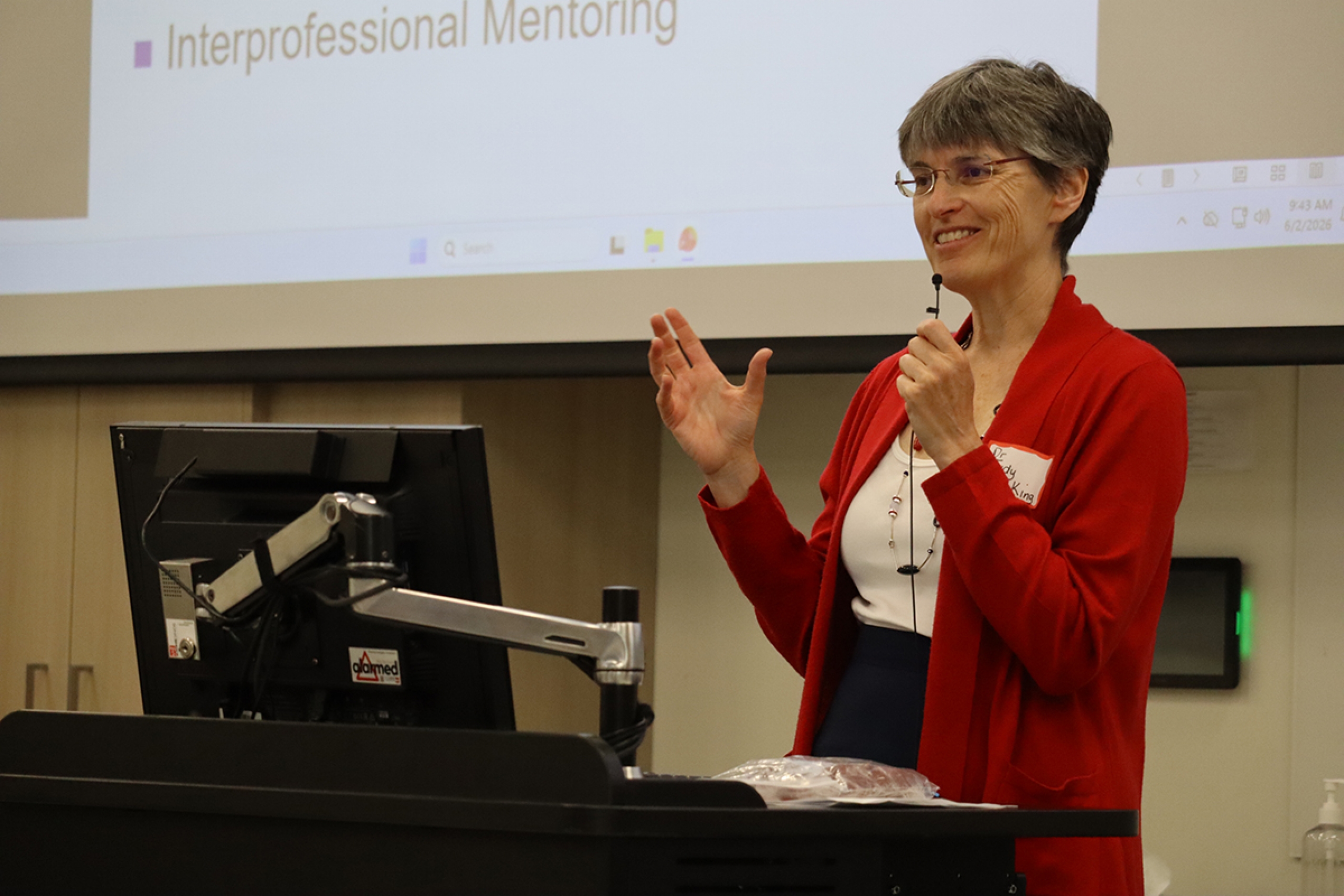 Dr. Judy King speaks at a podium.