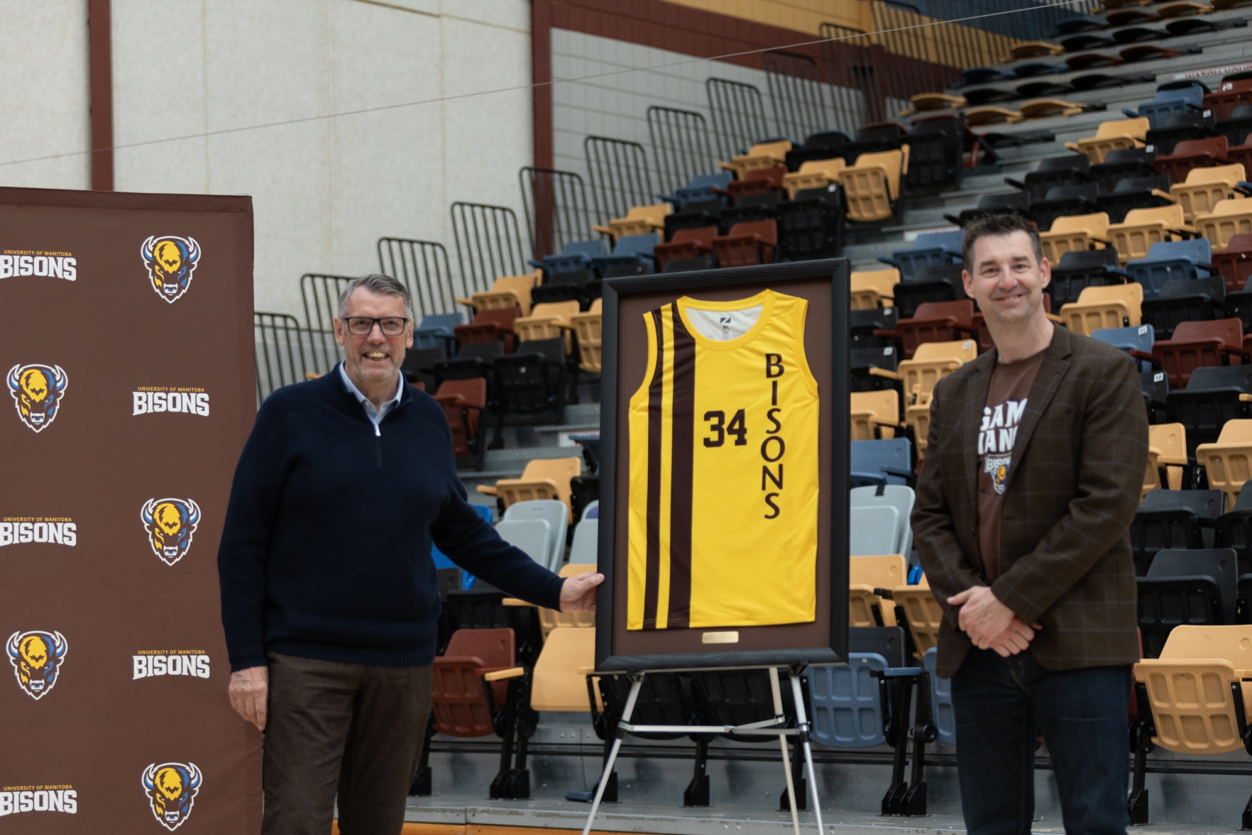 John Loewen and Coach Schepp presenting a framed basketball jersey