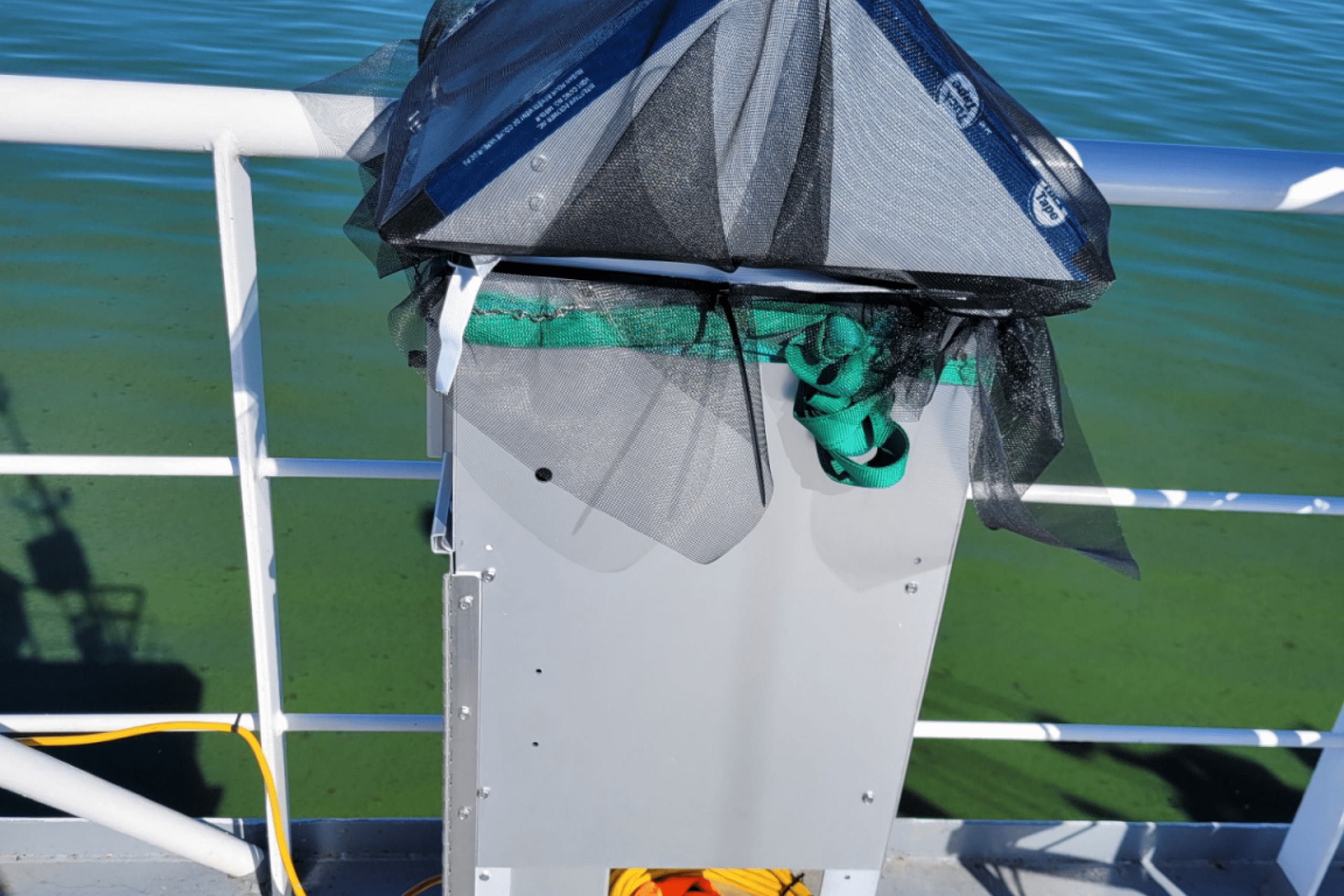 View of algea bloom on a lake from the deck of a boat