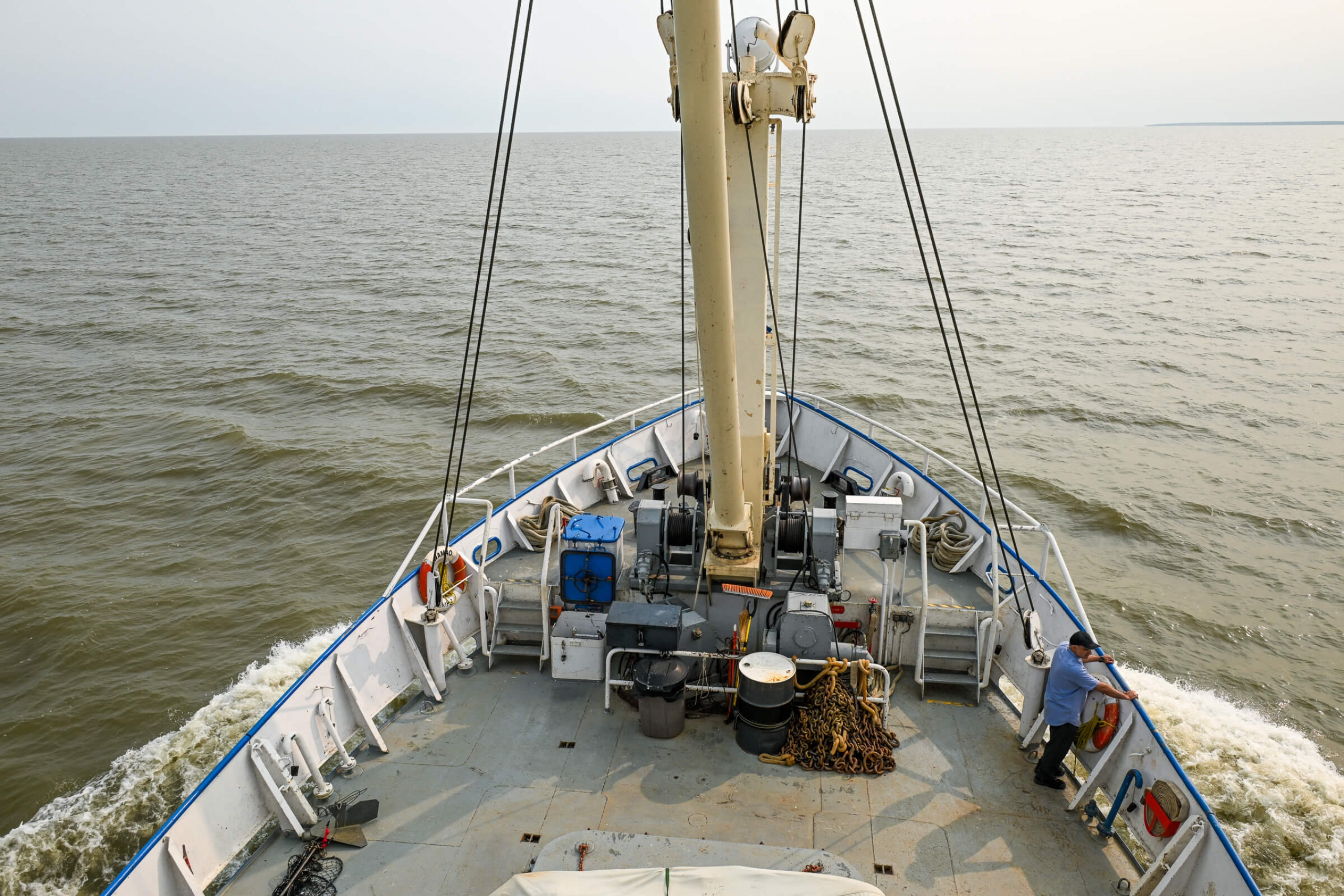 Photo of a research vessel on the lake with one crew memeber