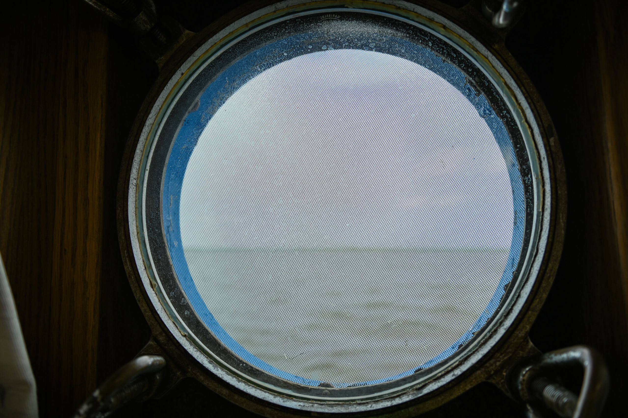 View out a porthole of the lake