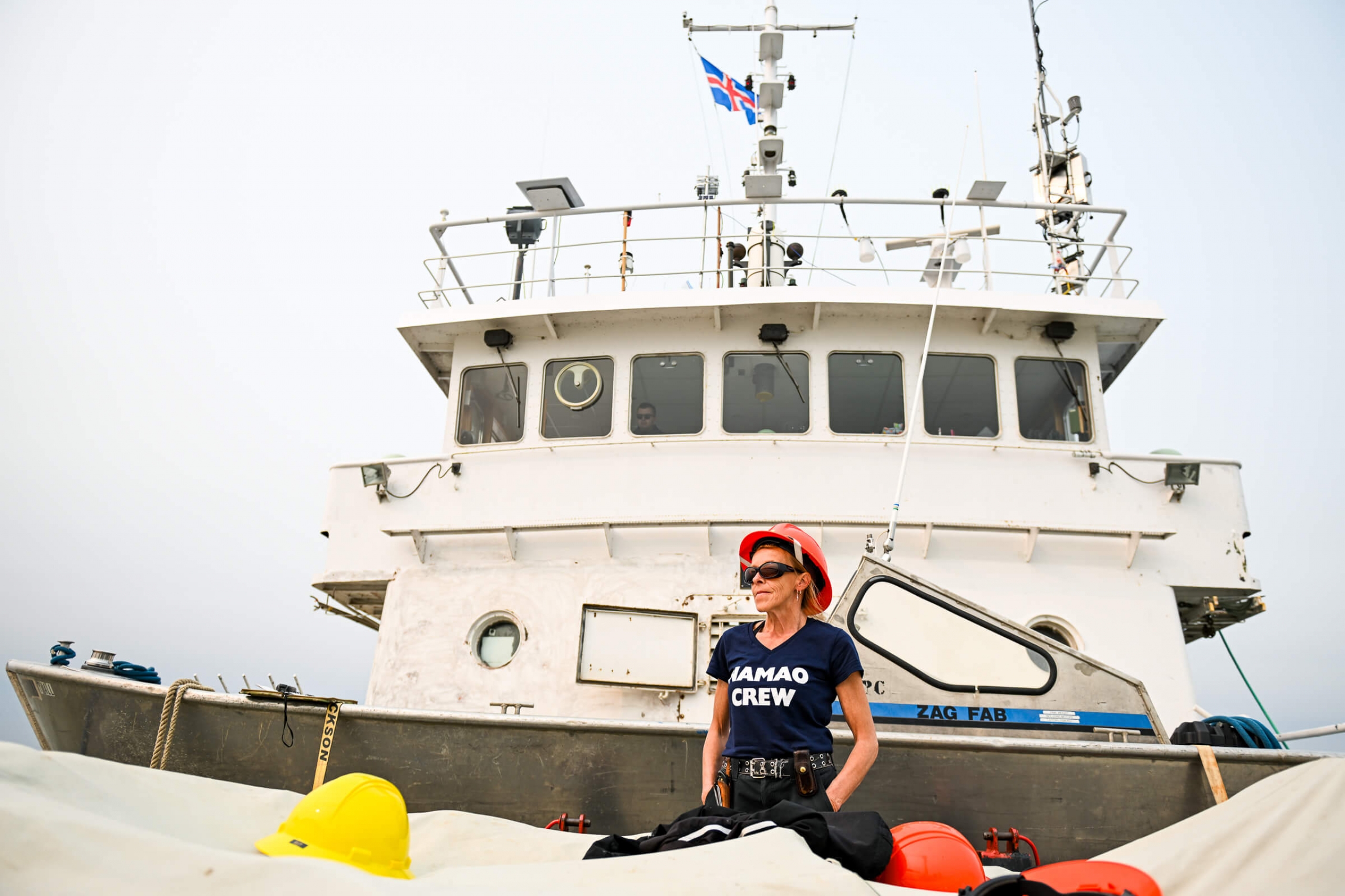 A woman stading proudly on the boat deck