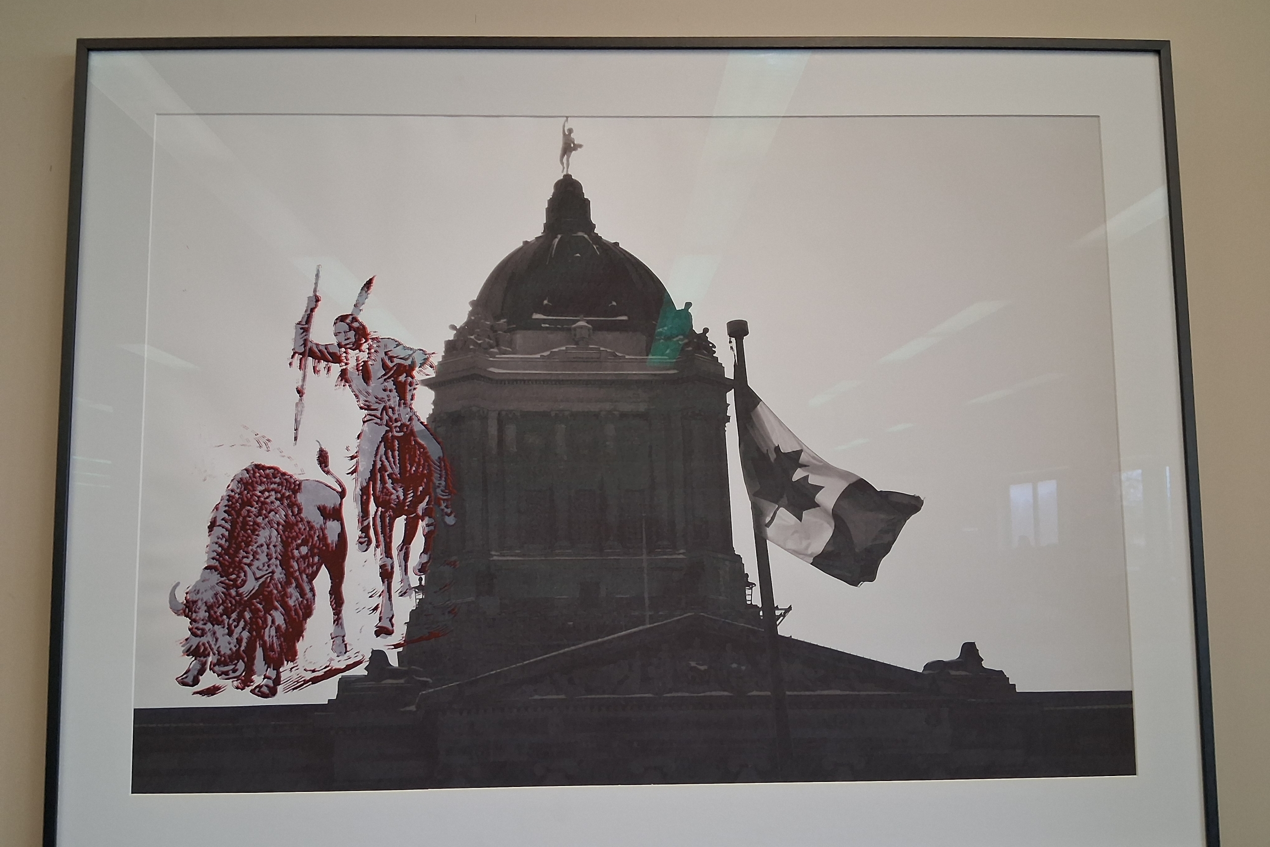 Art displayed in law library of graphic of traditional Indigenous man on photo of Manitoba legislature