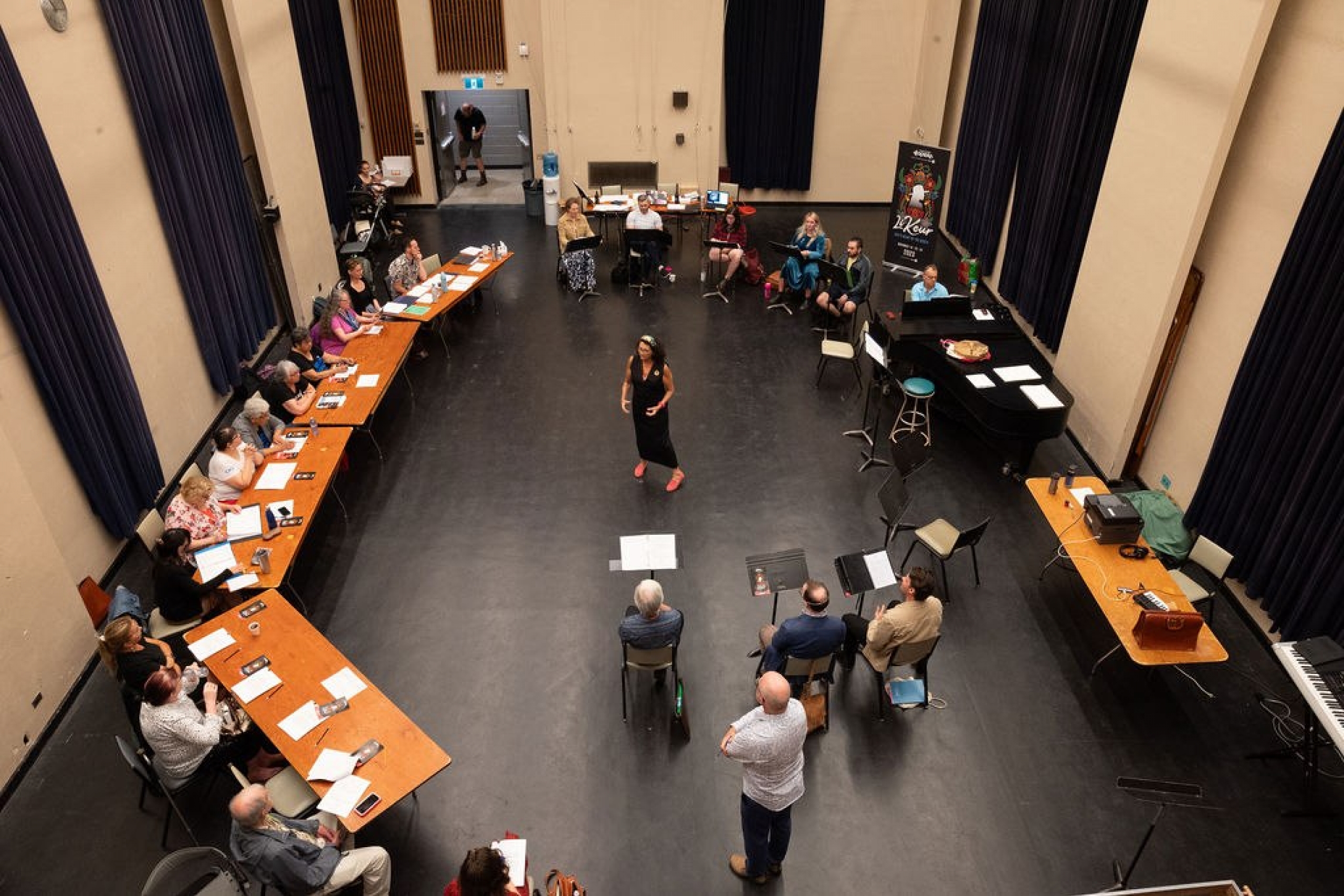 Arial view of people at tables in a circle for workshop.