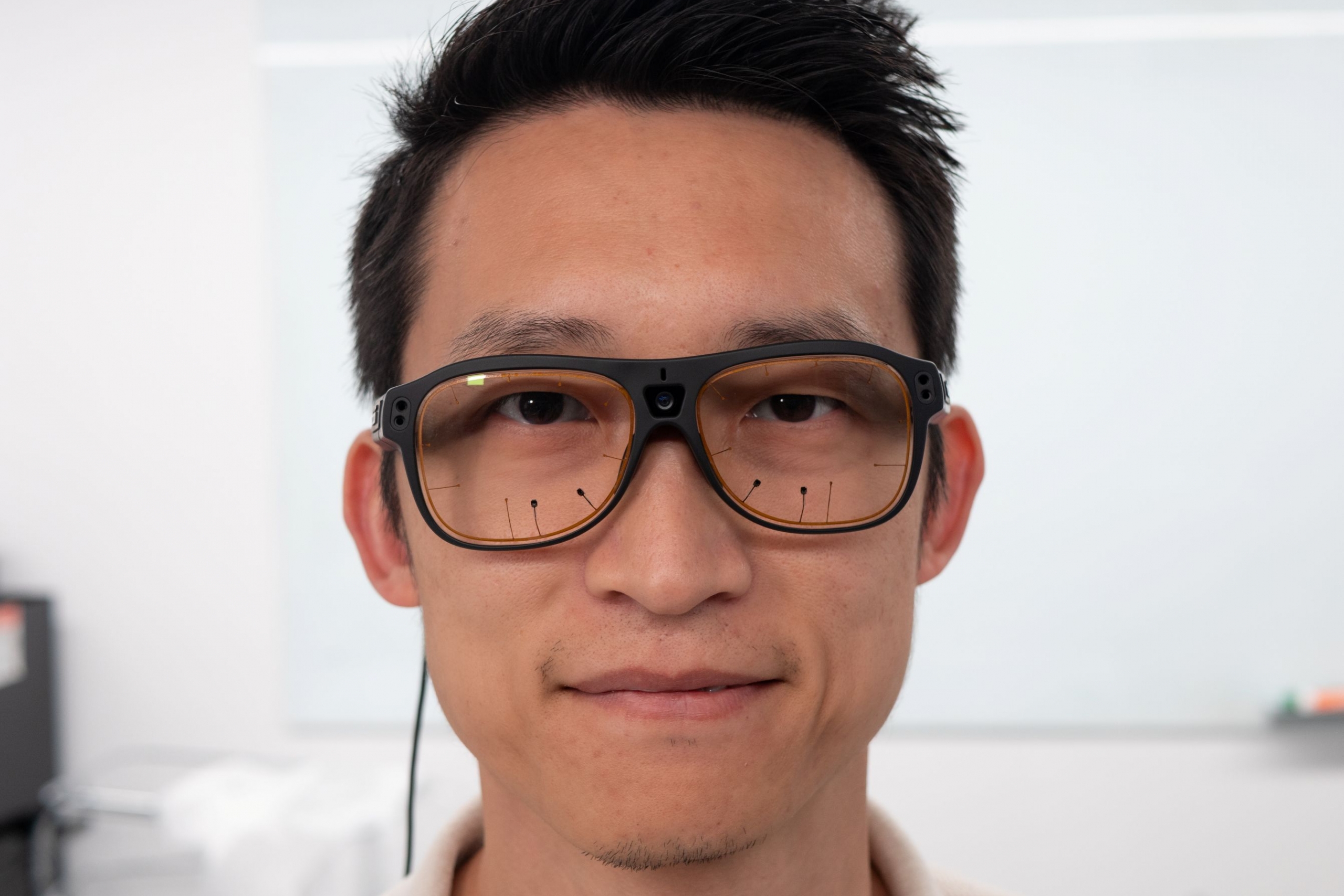 Terry Li wears glasses with eye-tracking software.  