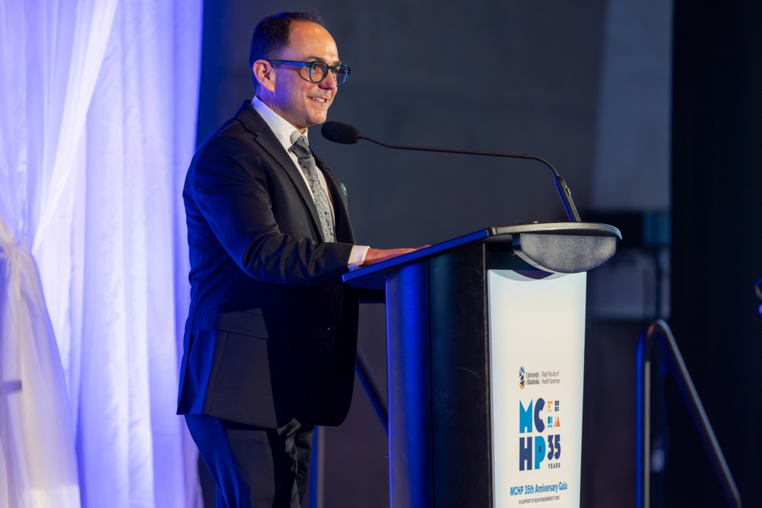A person speaking at a podium.