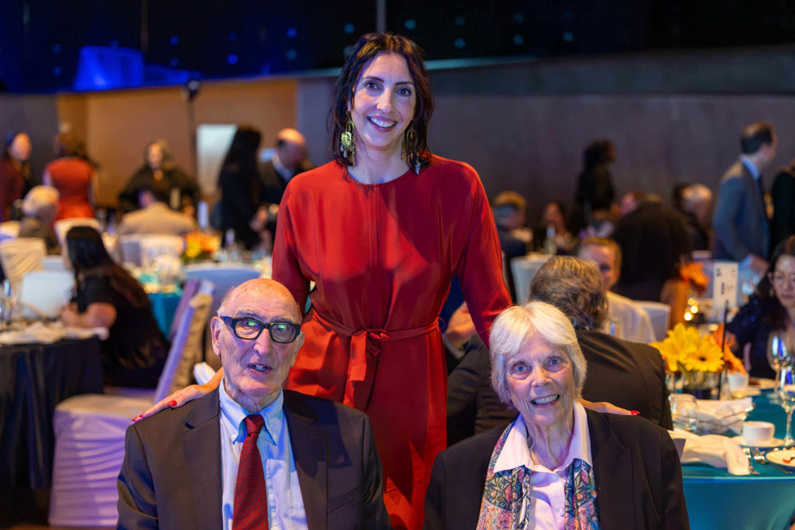 Three people smile at the camera.
