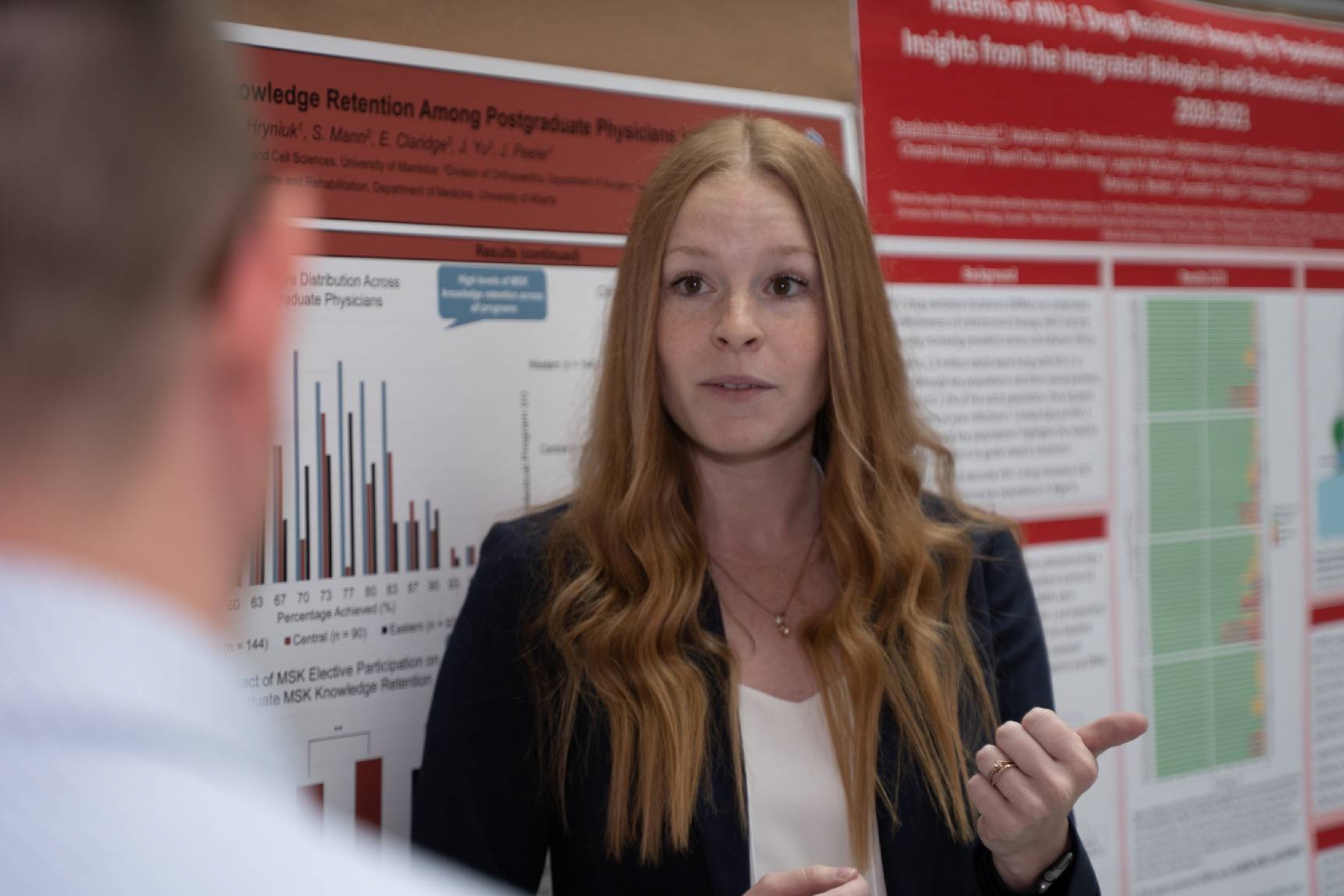 Student presenting research poster to judges.