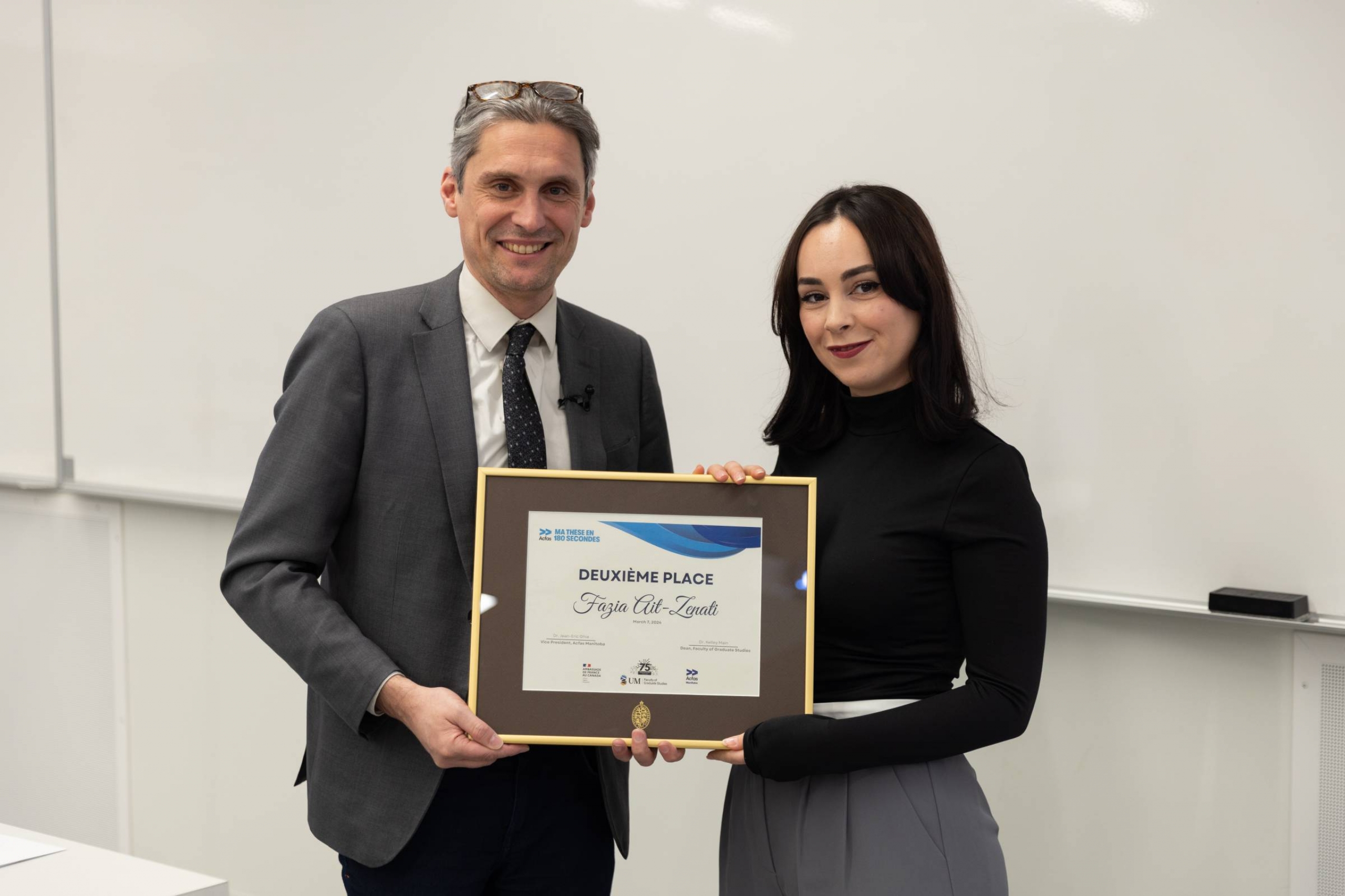 Fazia Ait Zenati receiving an award.