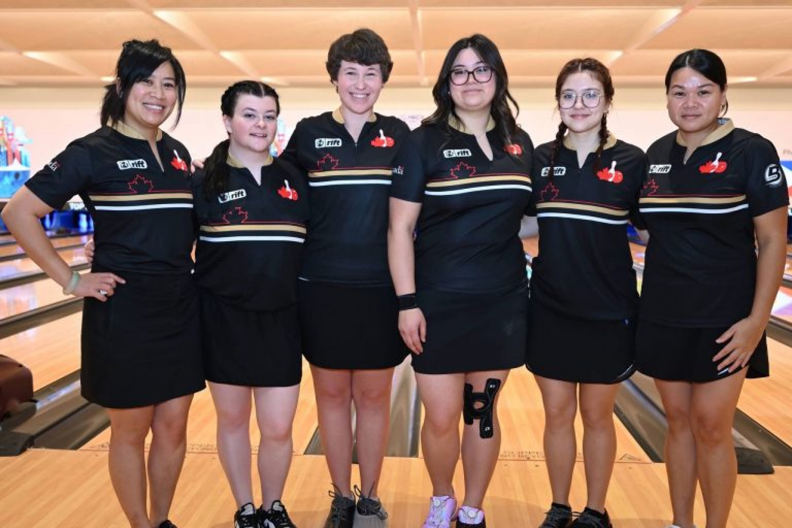 A group of bowlers at a bowling alley