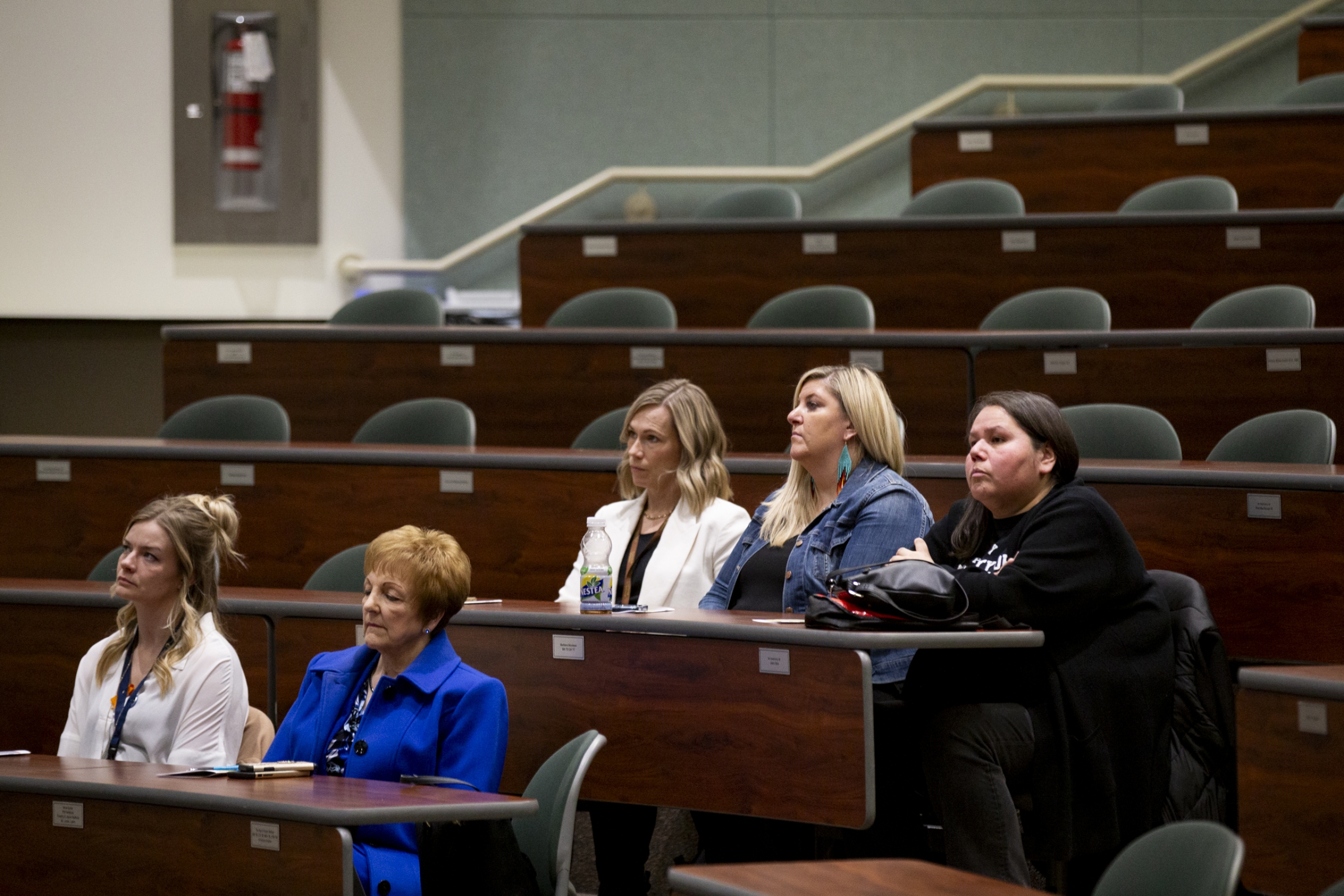 Audience members sitting in a theatre
