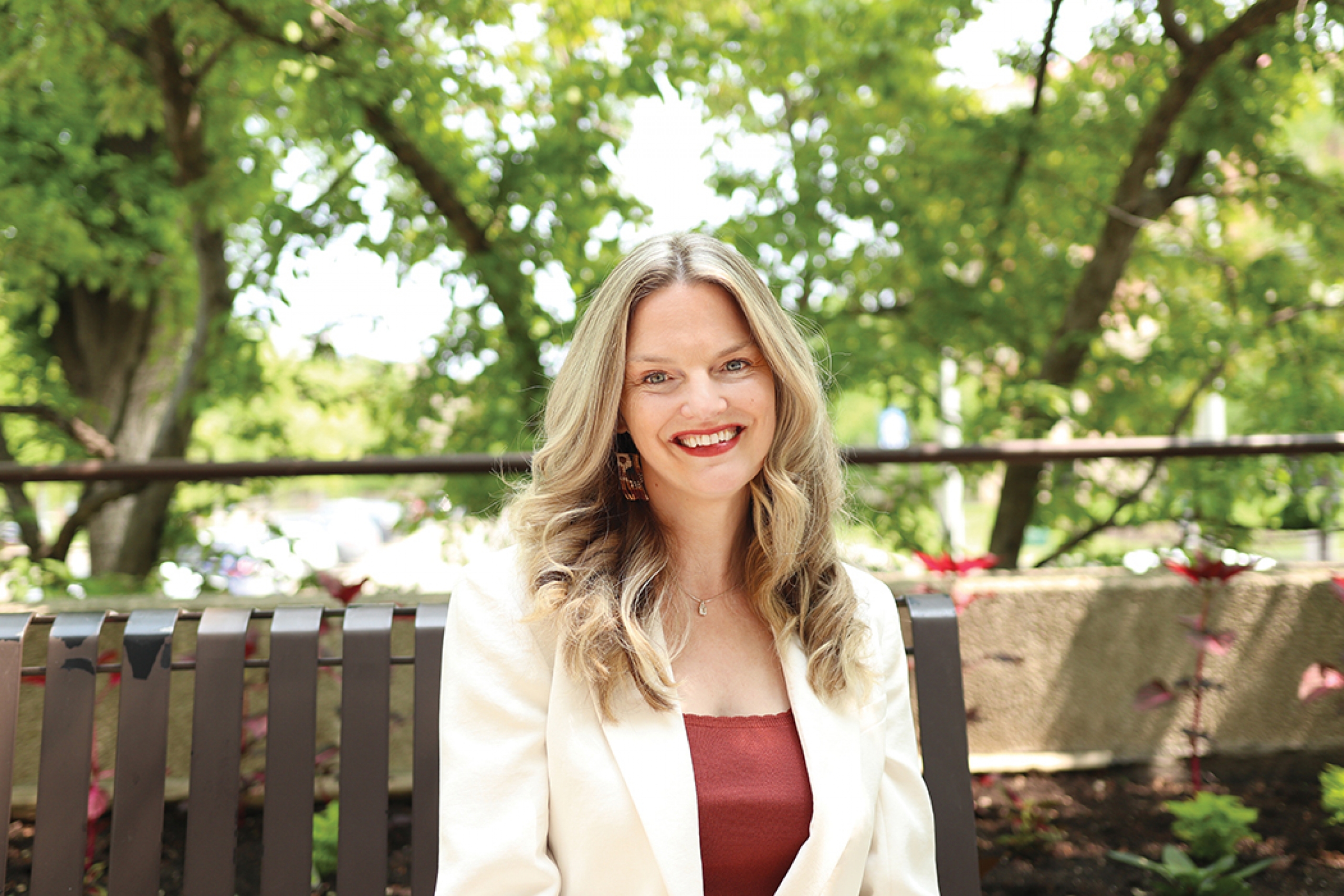 Marnie Kraker sits outside at Fort Garry campus.
