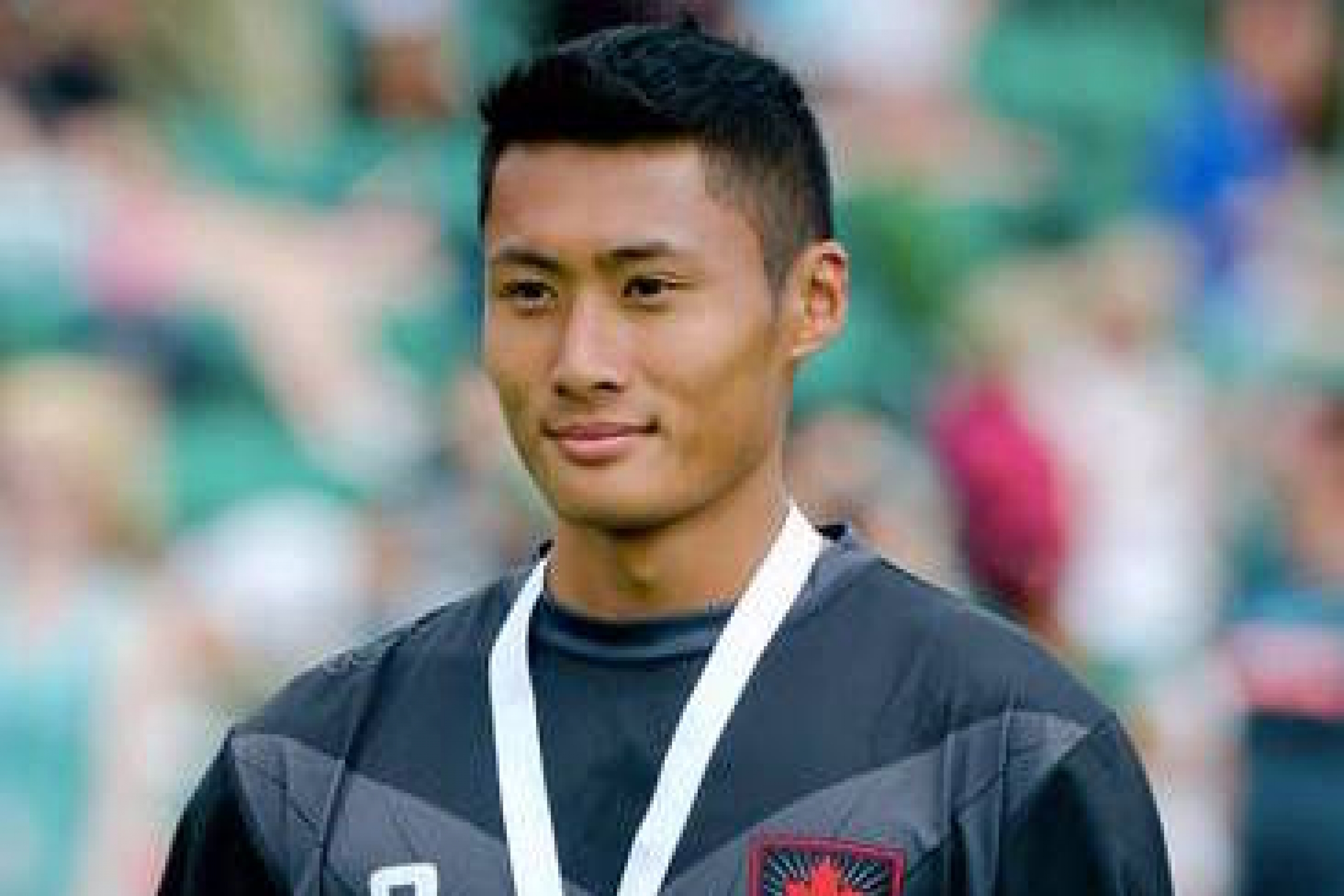 Elliot Wong with a medal in ultimate frisbee