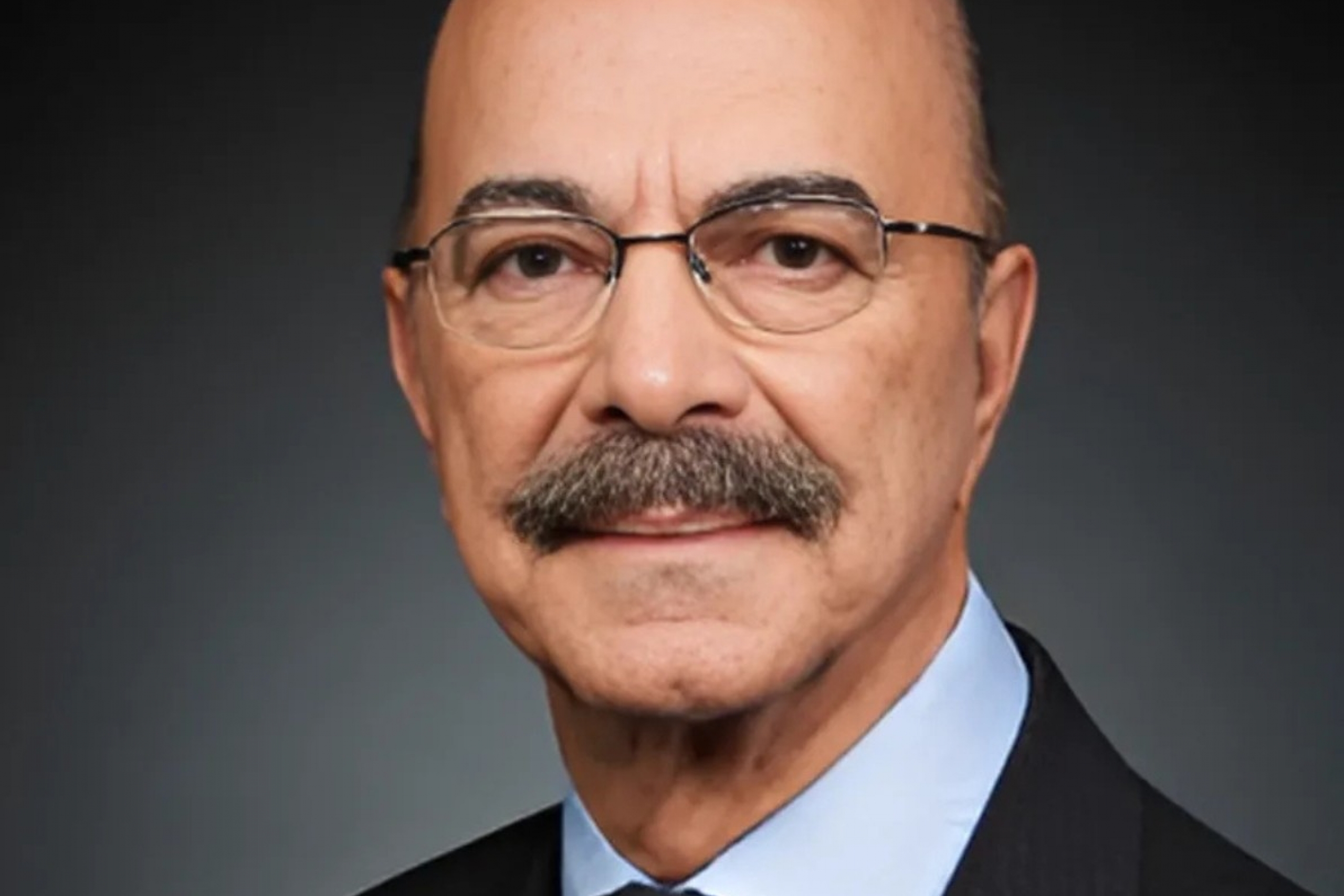 person with glasses in a suit and tie