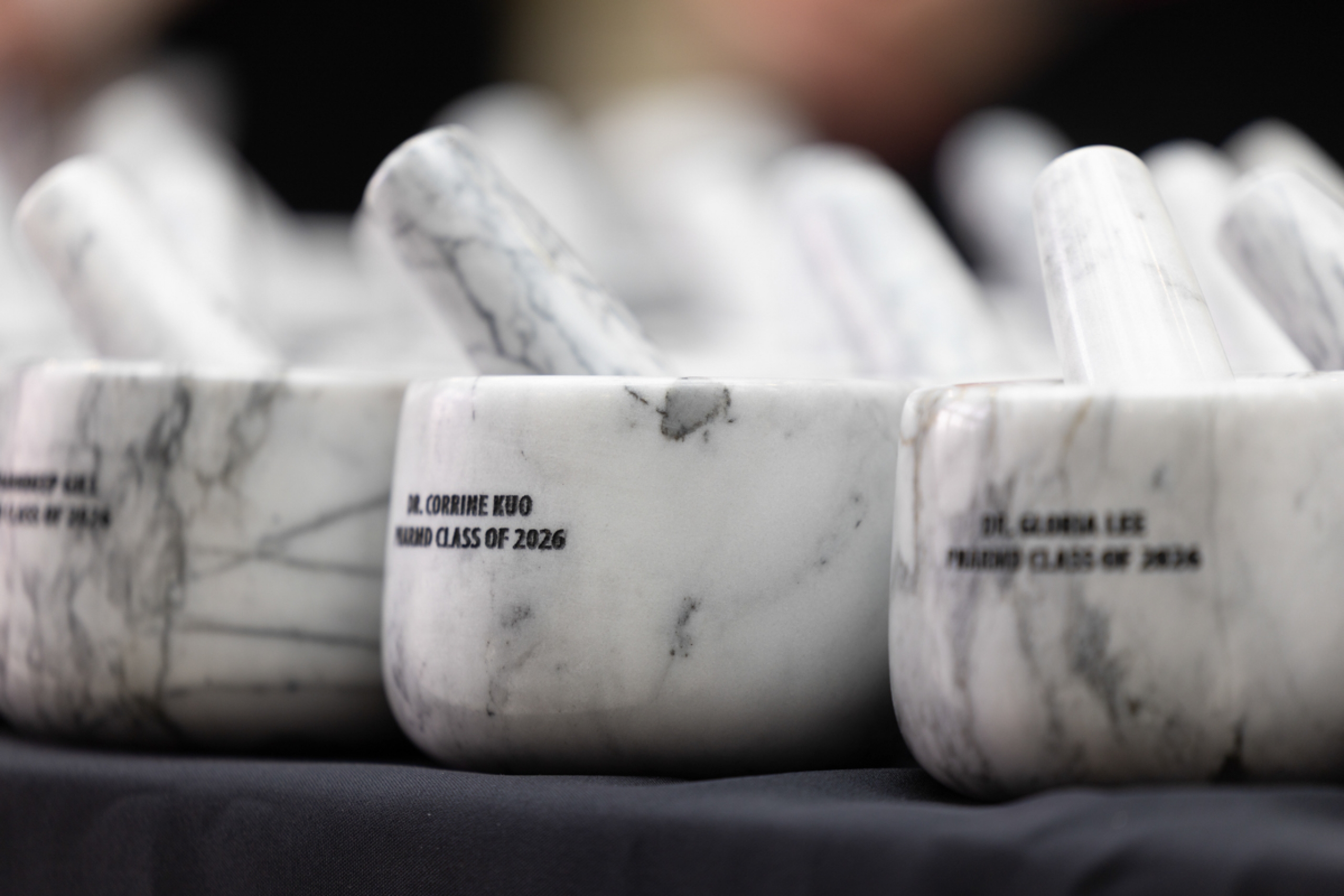 Mortars and pestles engraved with graduate names.