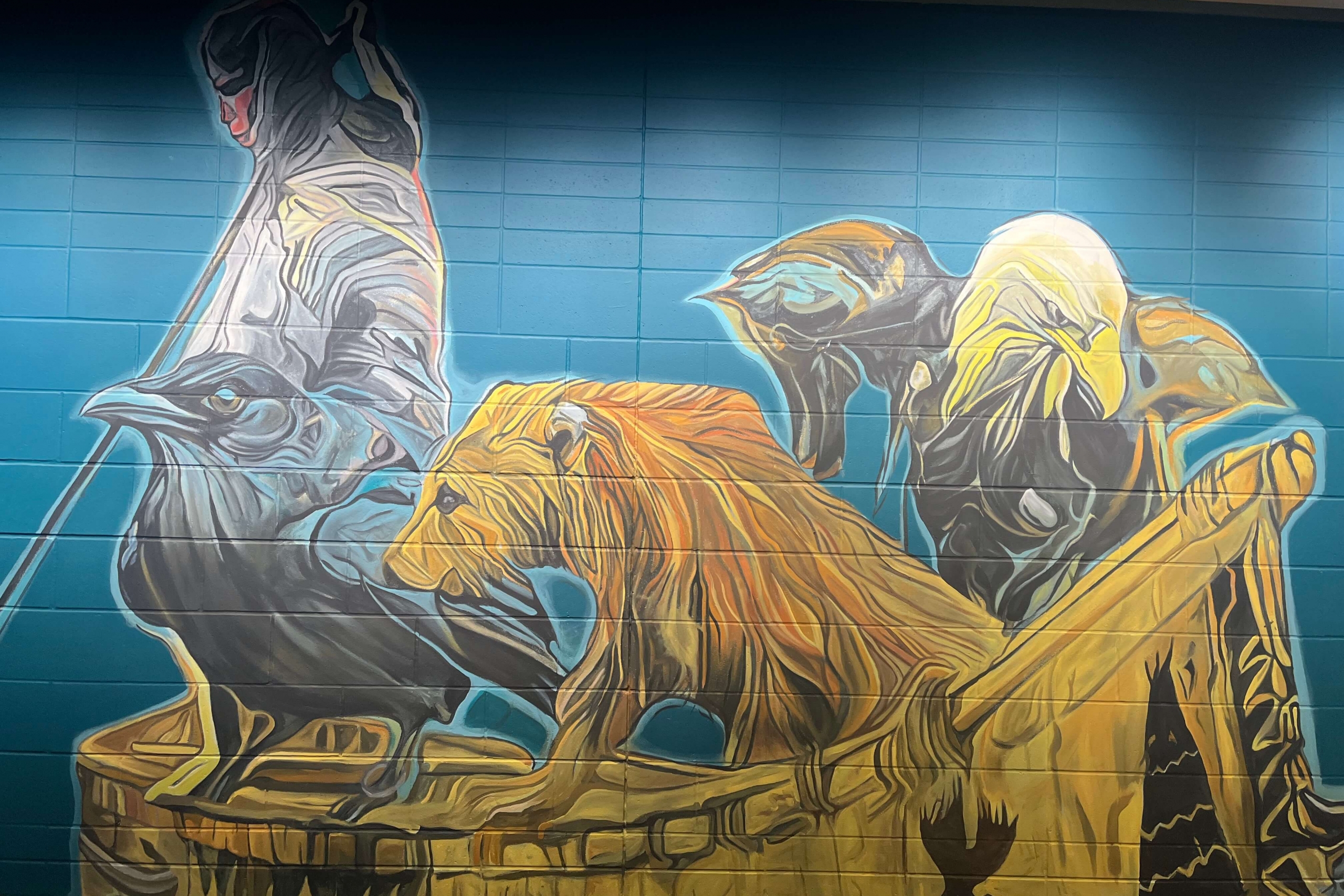 bear, fisher and eagle on a canoe depicted on a mural