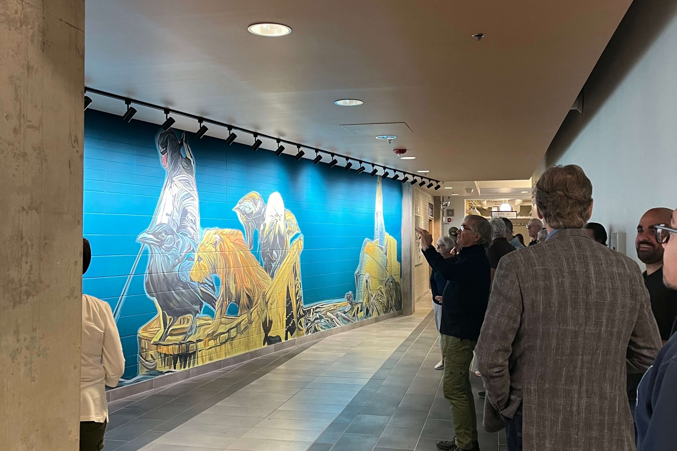 People viewing and taking pictures of a mural