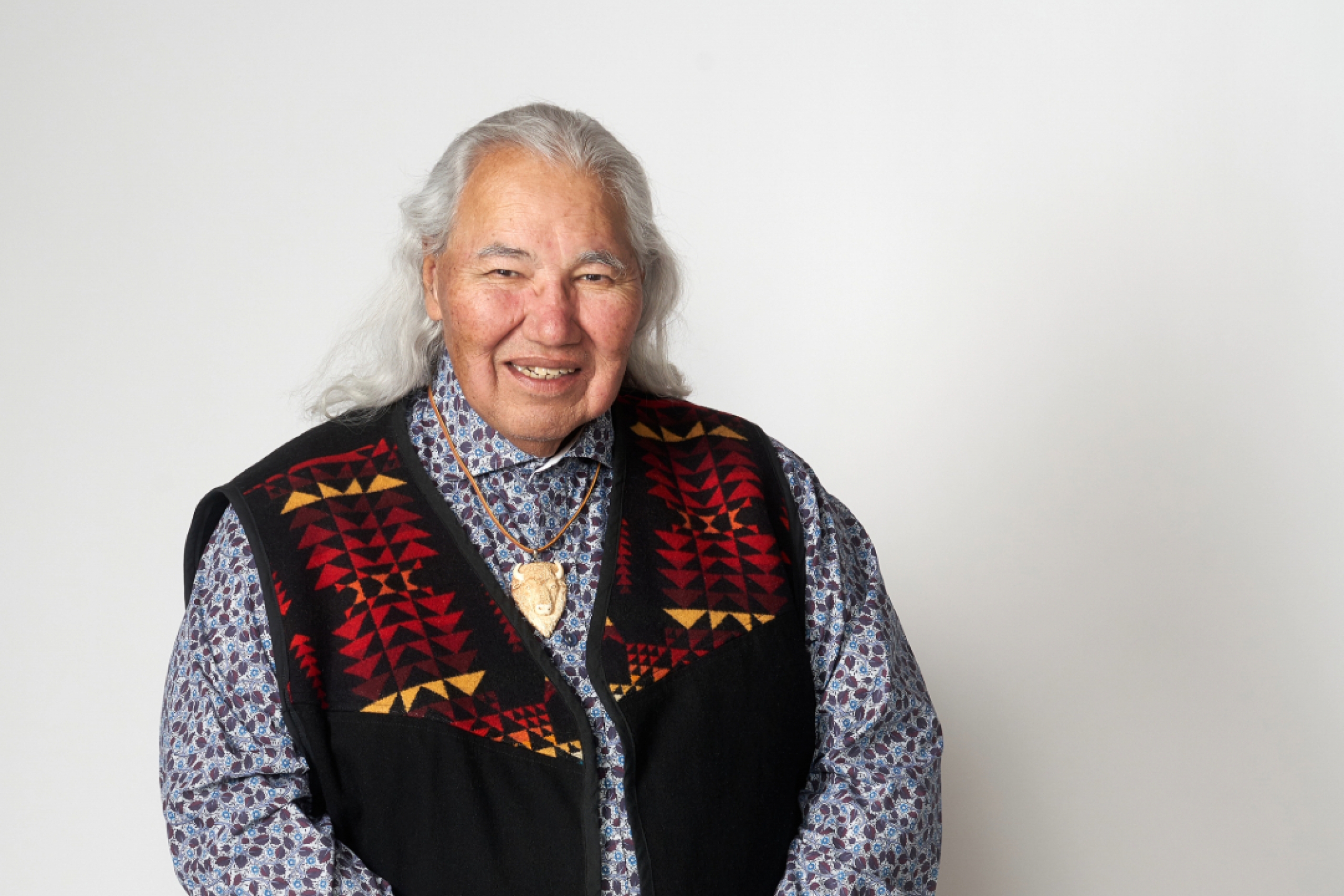 Murray Sinclair poses against a white wall.