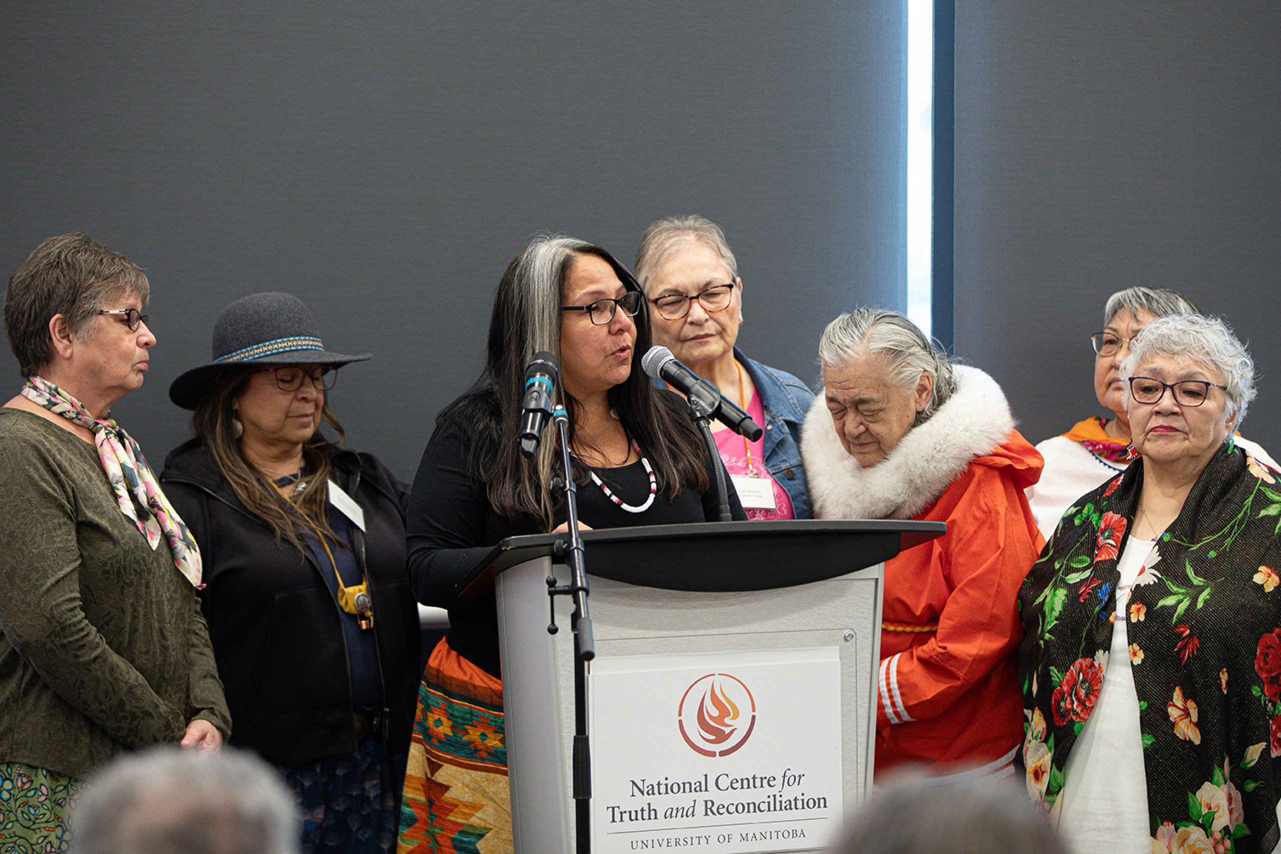 Stephanie Scott surrounded by female Elders and Survivors