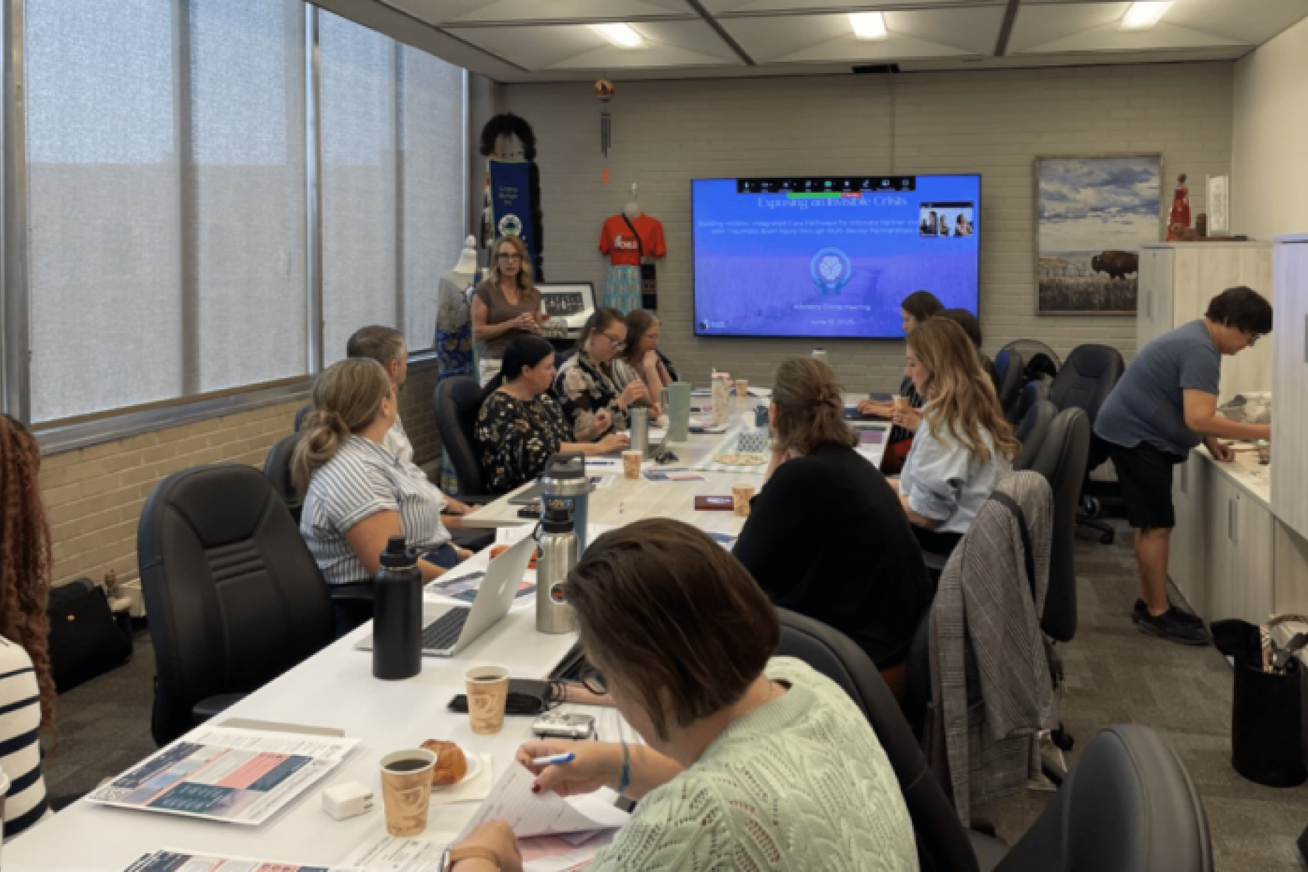 Dr. Nixon's team sits around a long table in discussion.