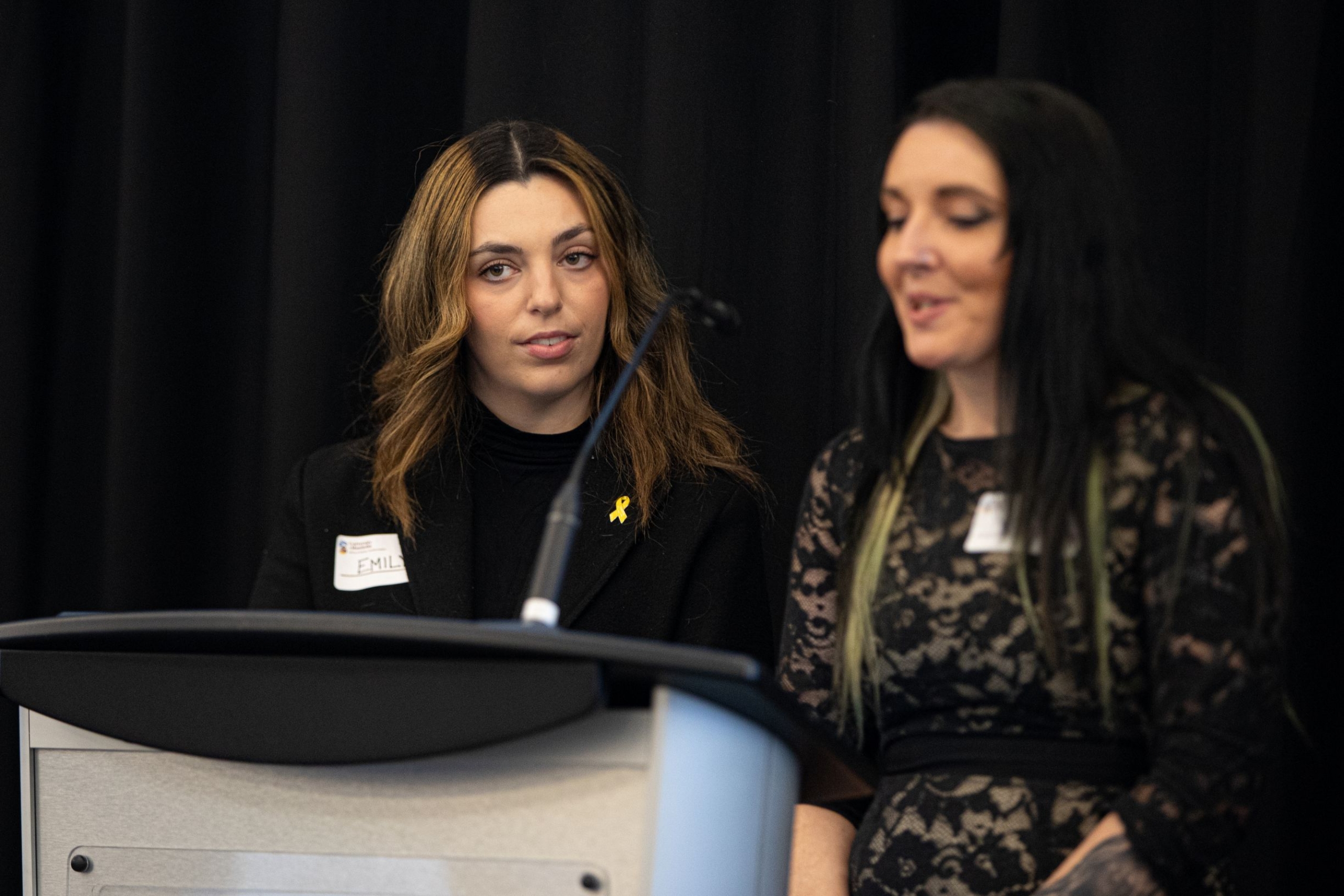 Two people present at a podium.