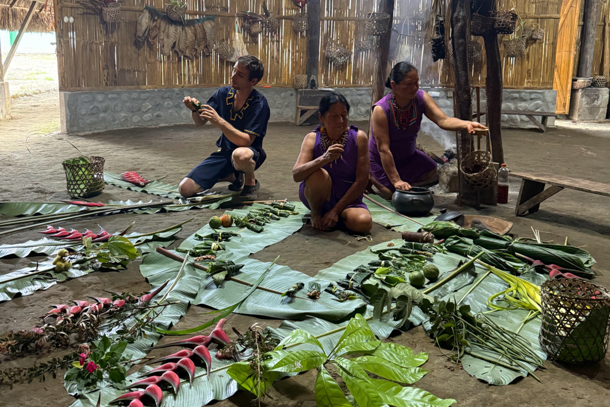 Three people preparing traditional medicines.