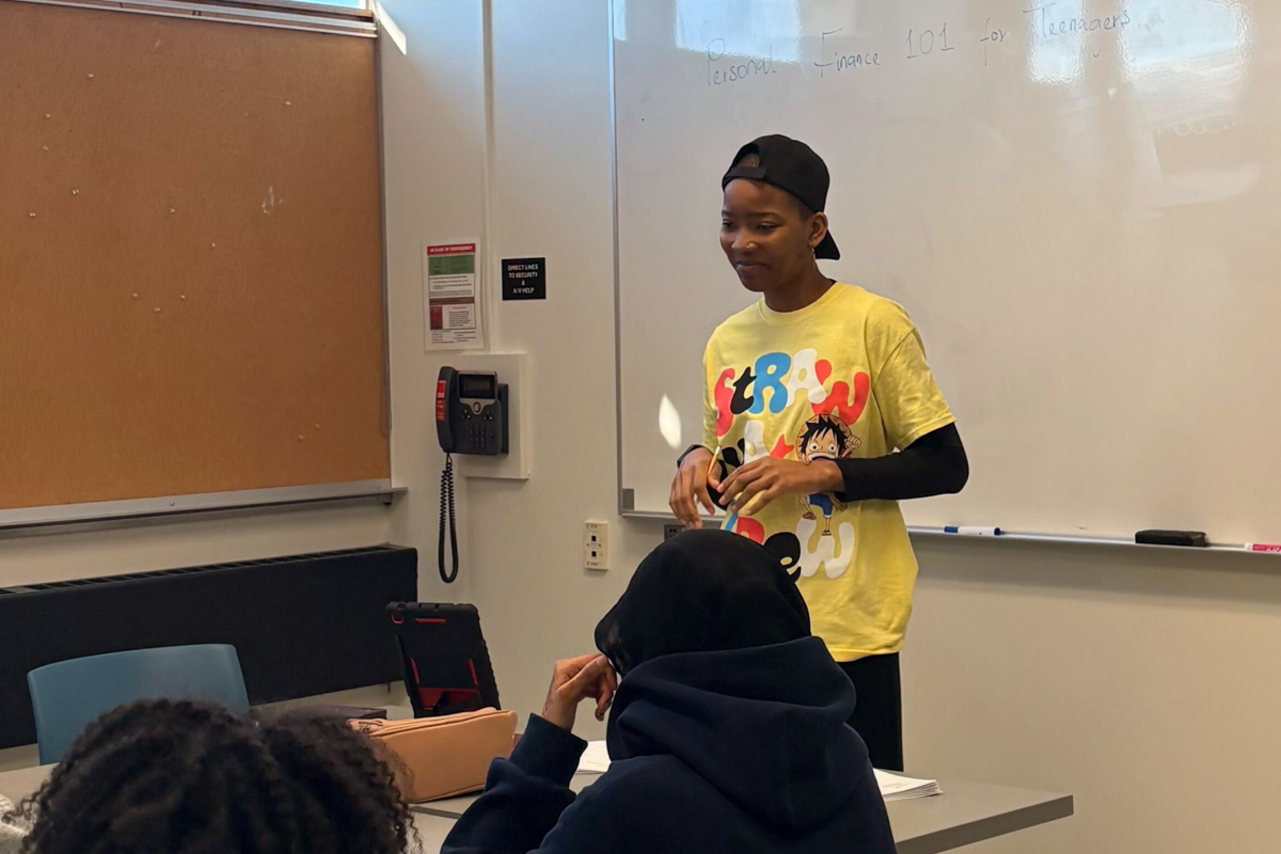 A person teaches a group of youth.