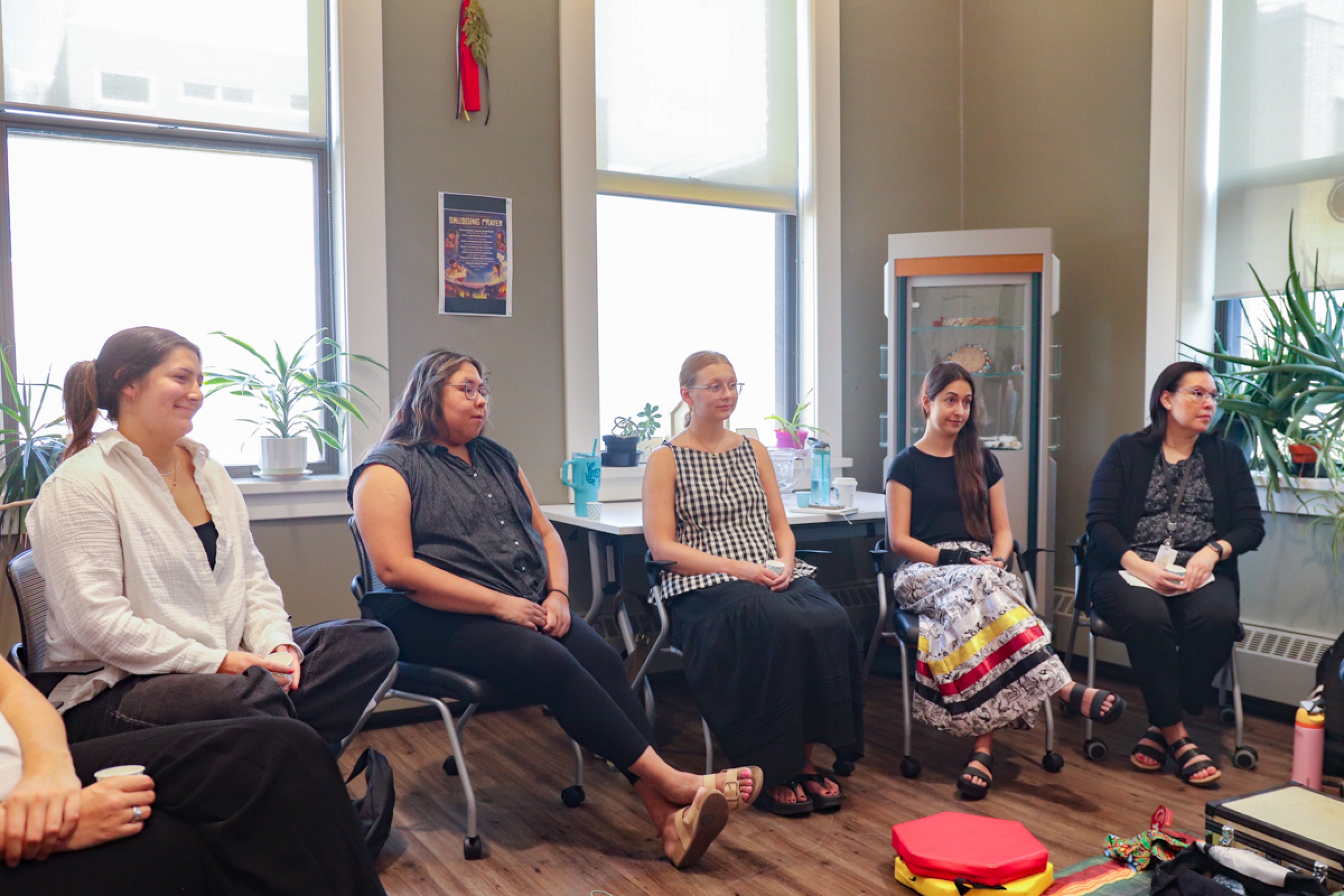 Five people sitting in a room.
