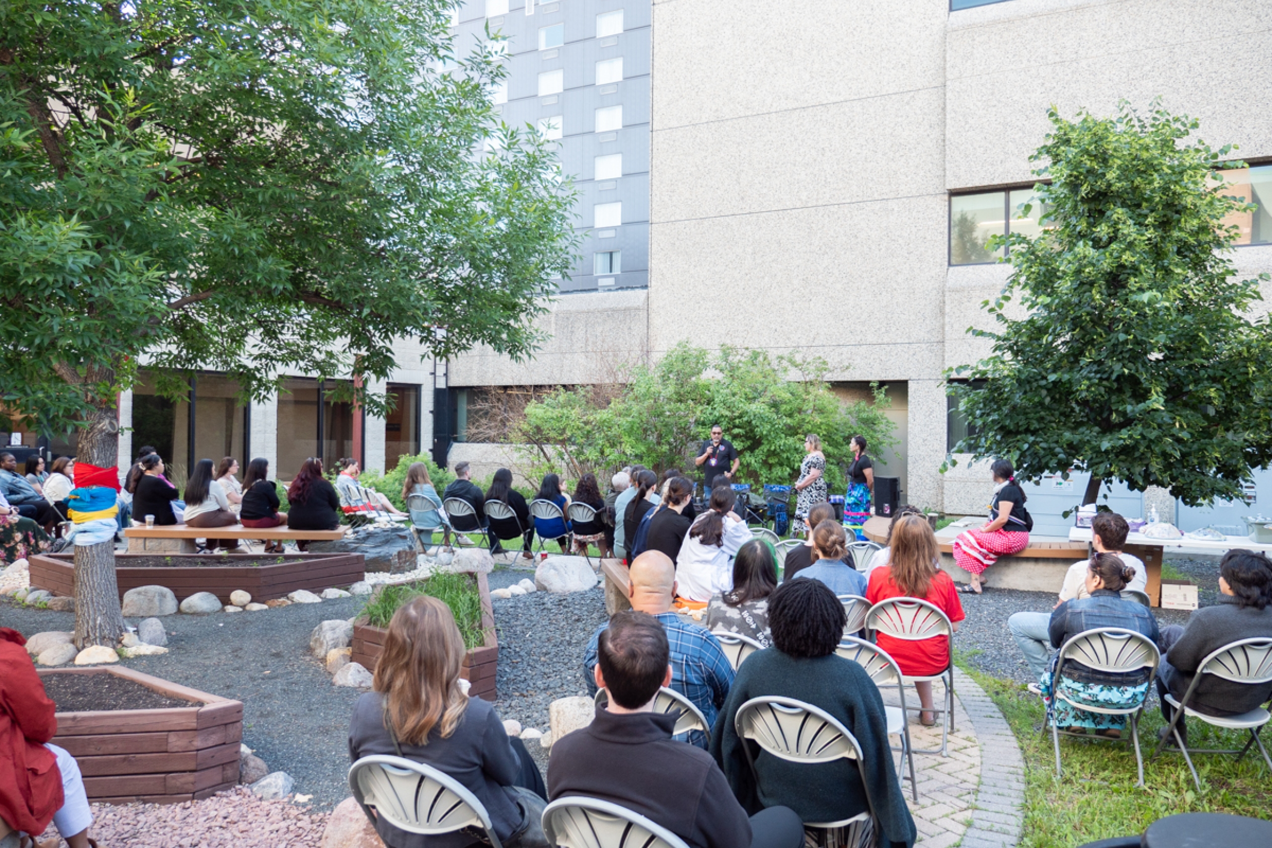People gathered outdoors in a garden.