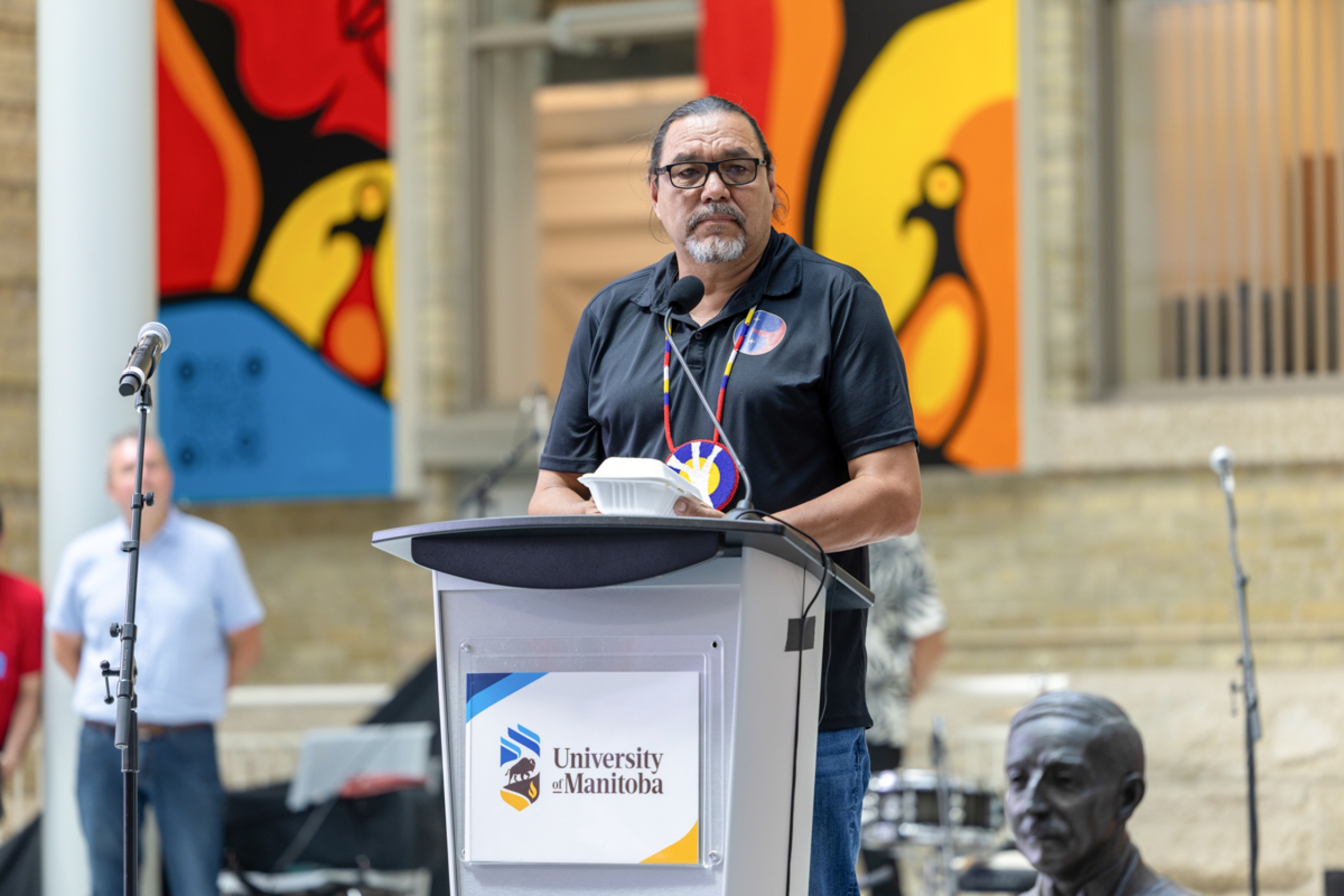 A person stands behind a podium.