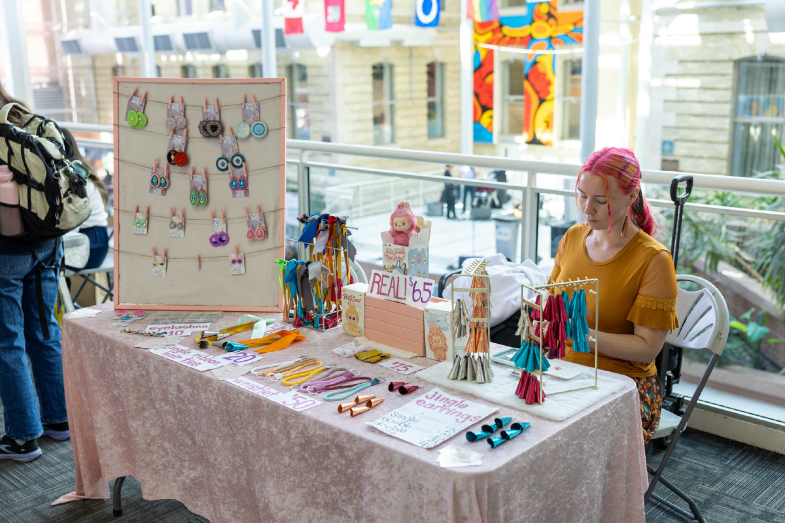 A vendor with items to sell on a table.