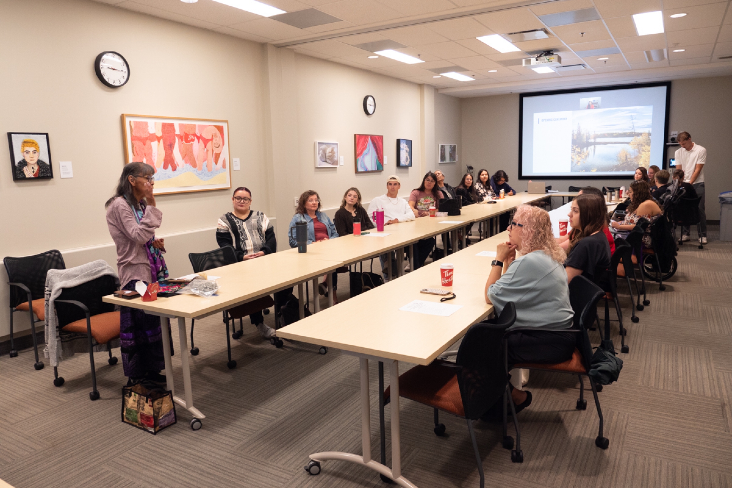 A group of people seated in a boardroom.