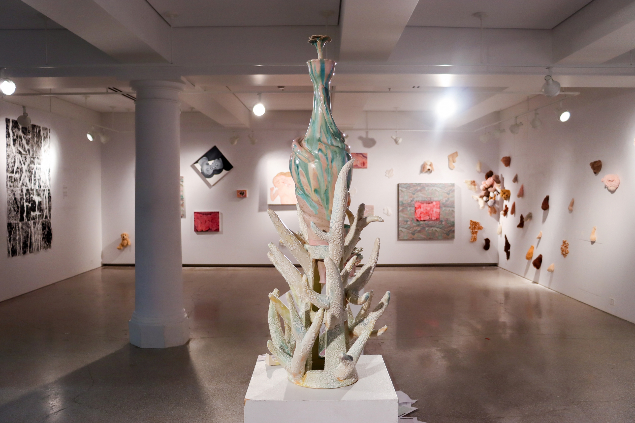 Gallery view with tall ceramic sculpture centered in exhibition space