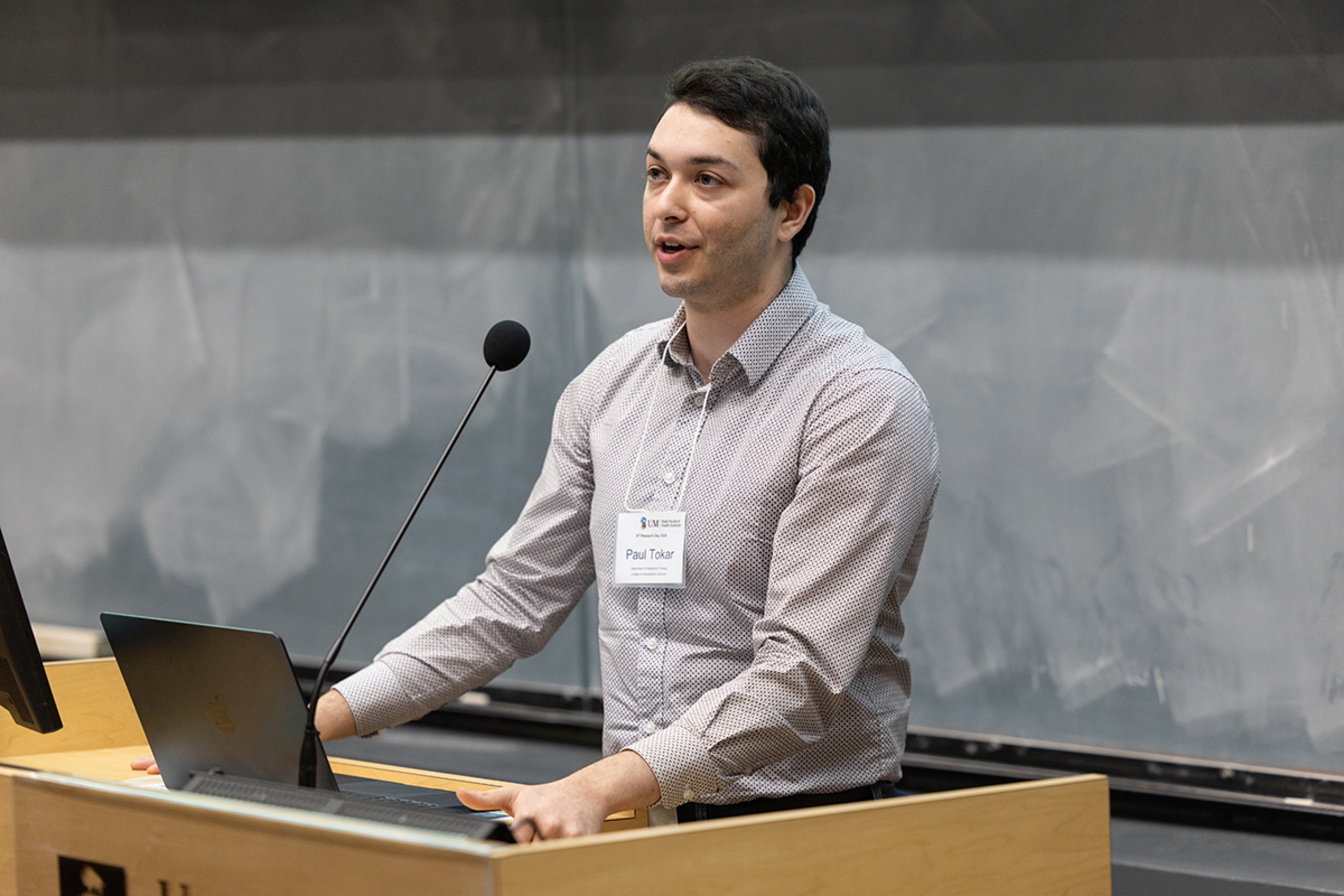 Paul Tokar speaks at a podium.