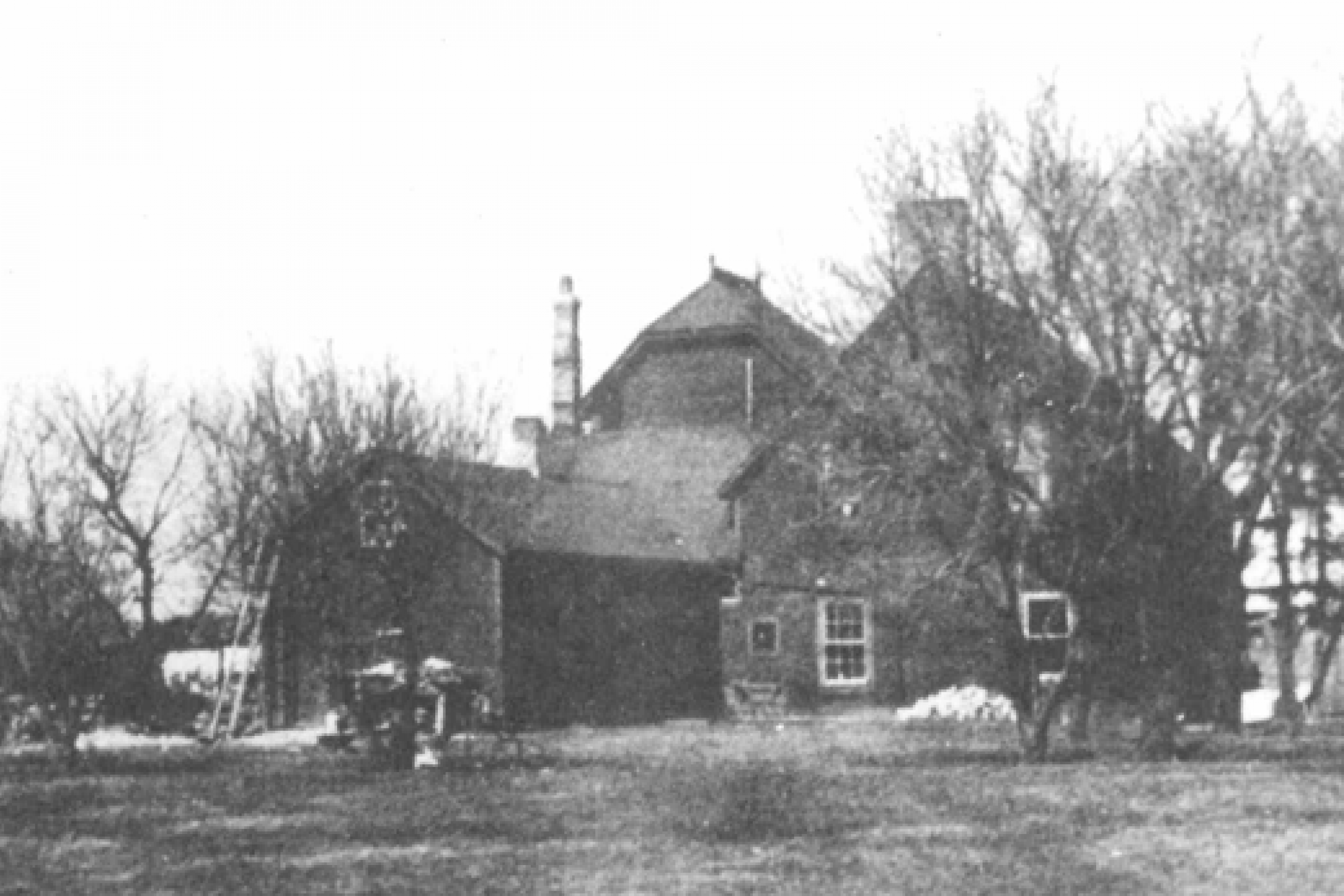 Black and white photo of a large wooden house.