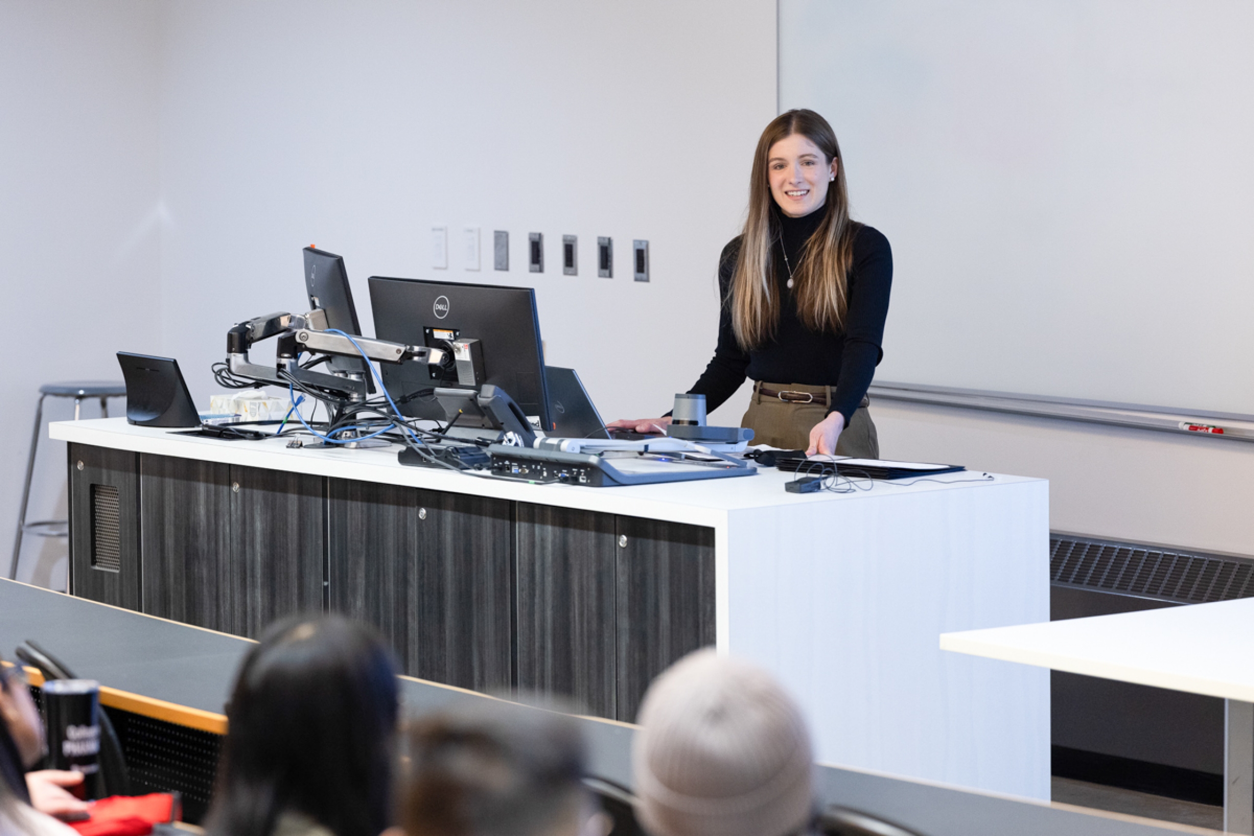 A student presenting in front of a crowd.