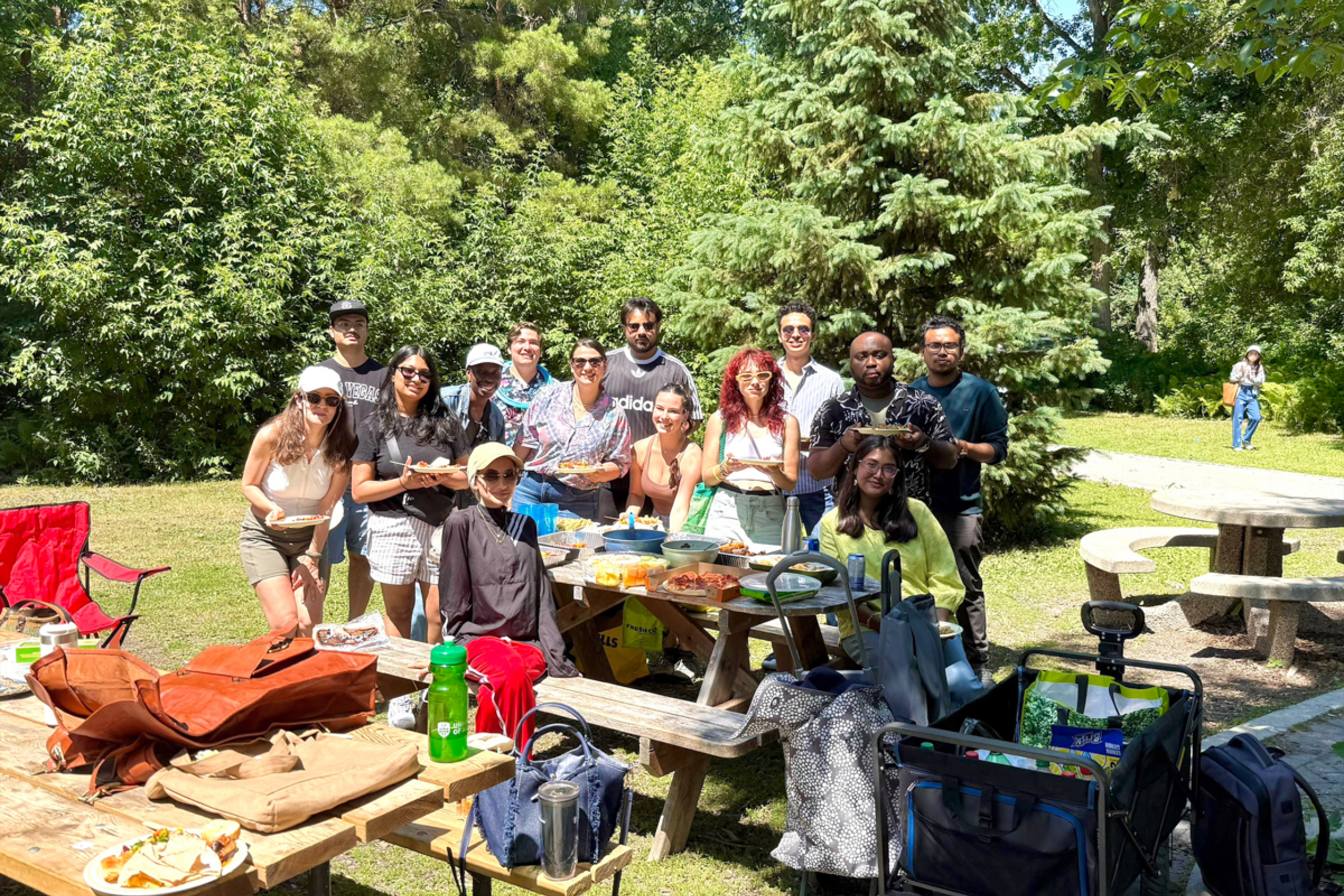 Group photo of students outdoors in a park in summer.