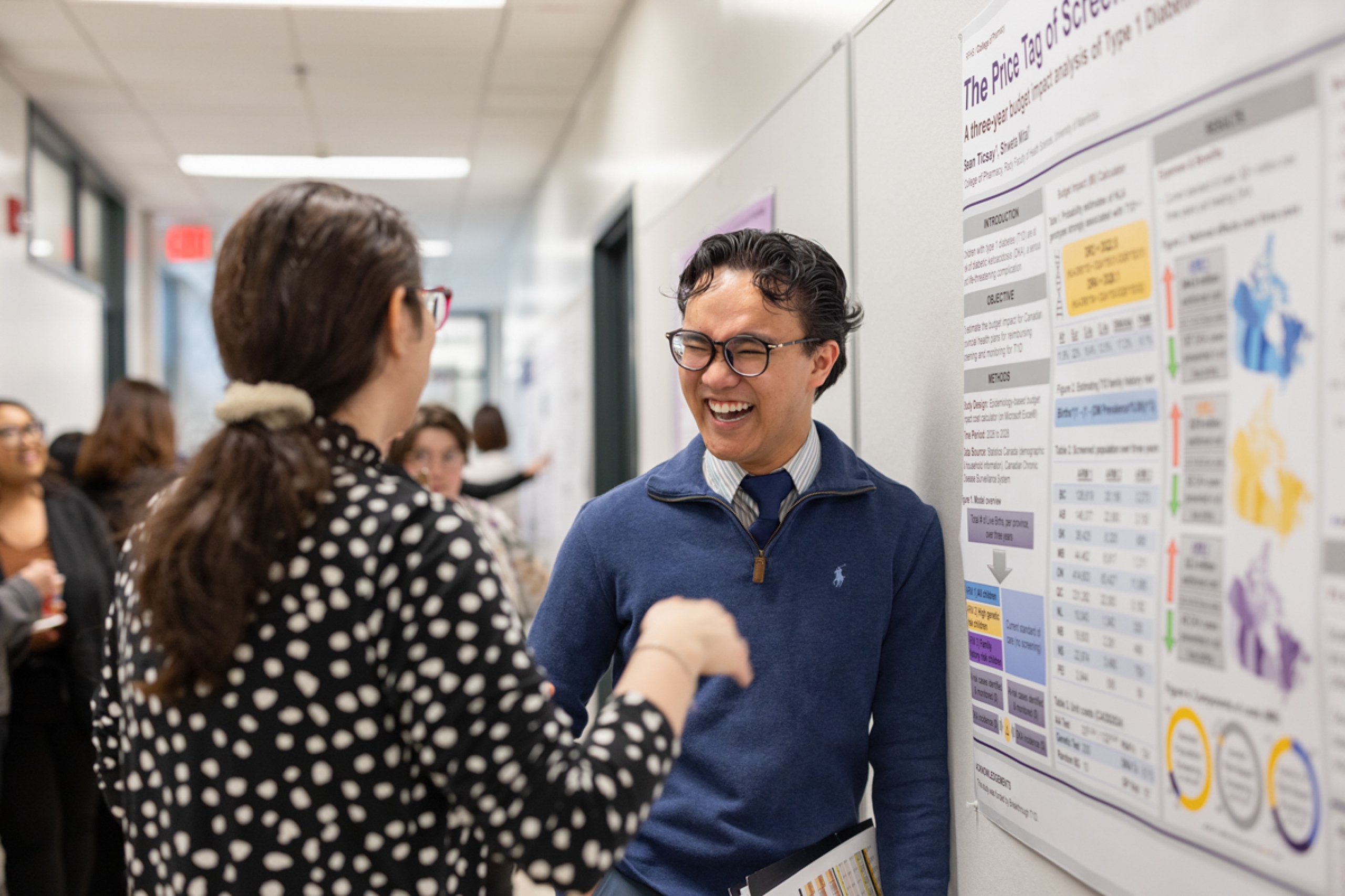 A student smiling while talking to another person.