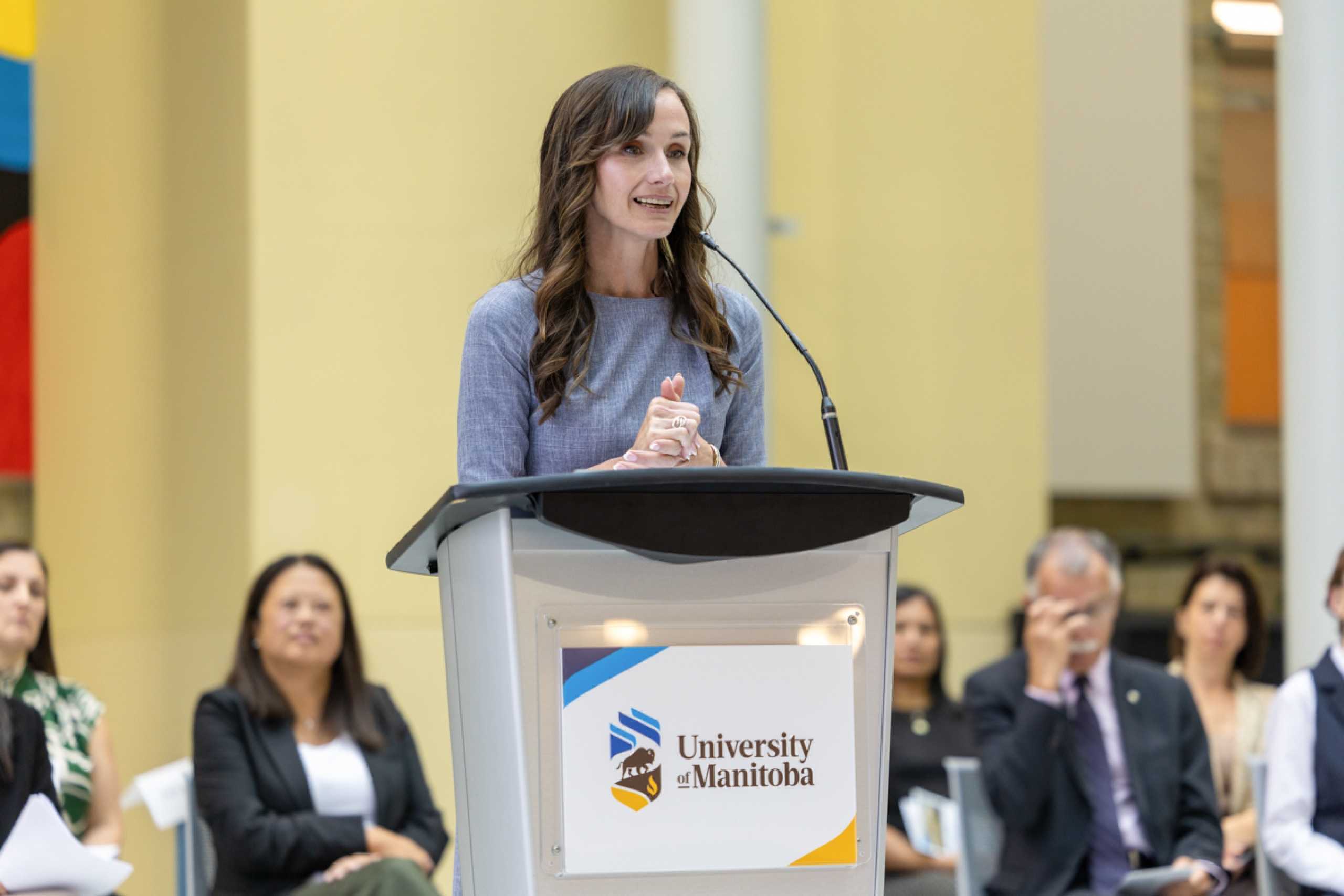 A person speaking at a podium onstage.