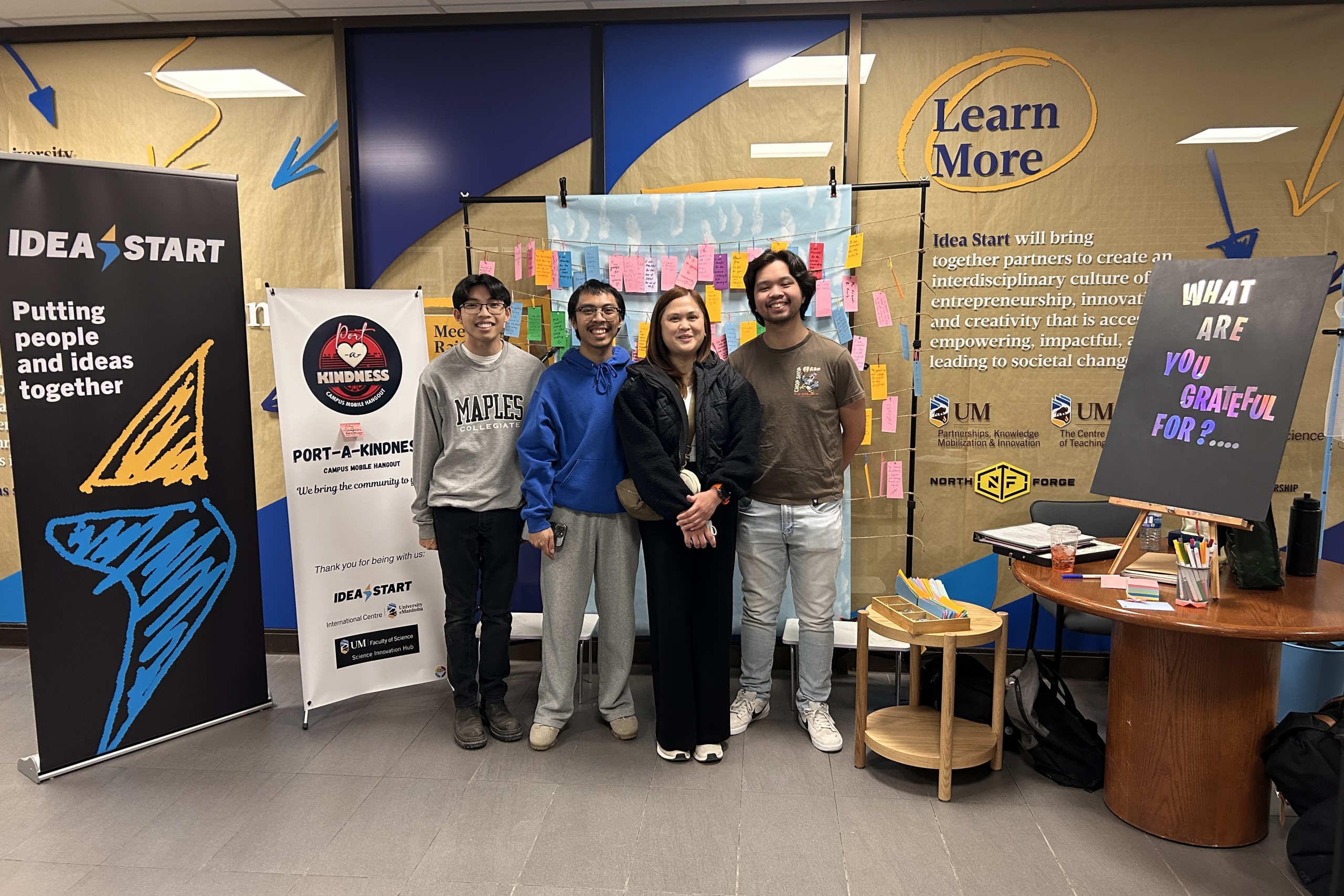 Group photo of people in a hallway.