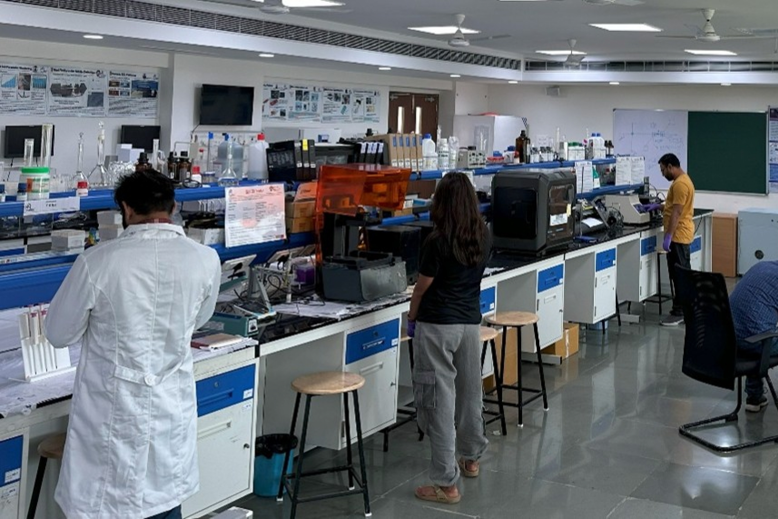 Researchers wear clean suits in the lab.