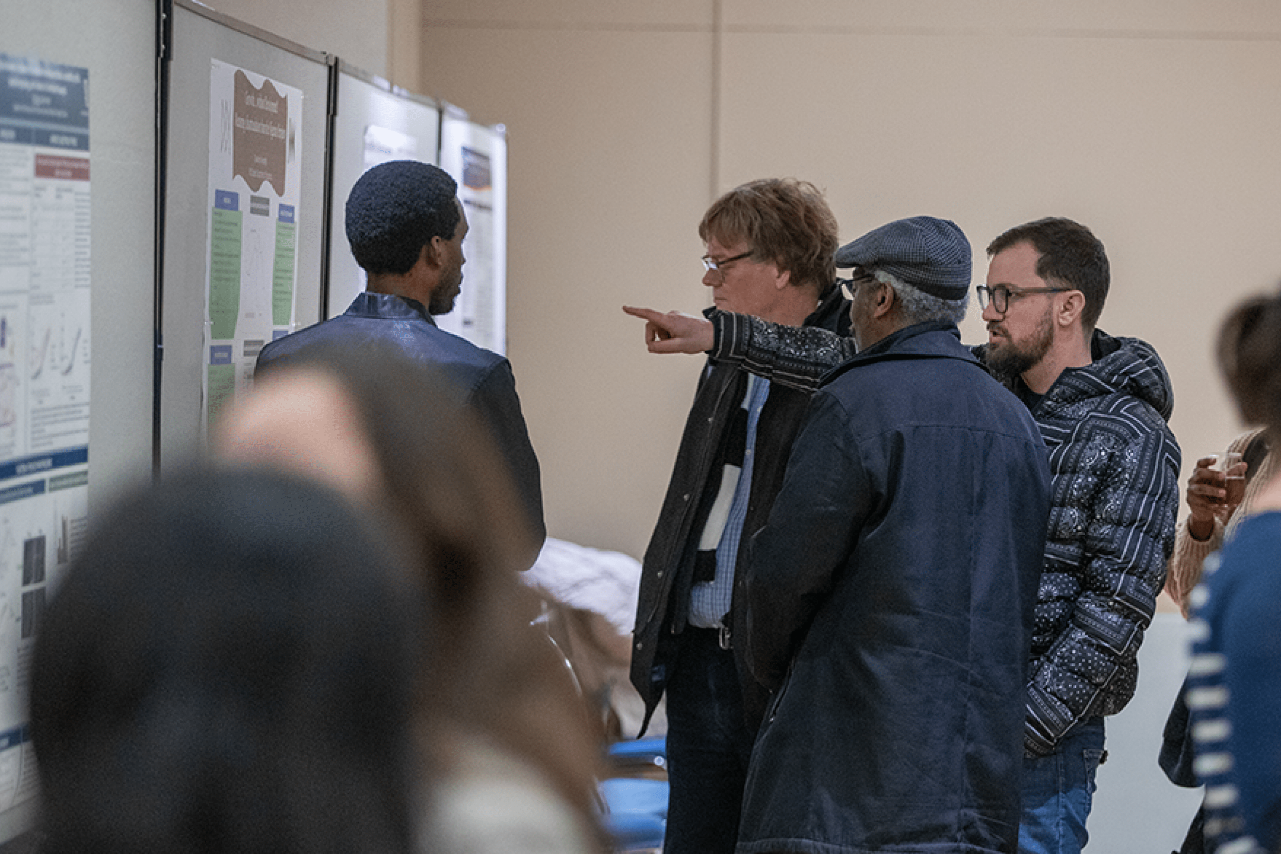 a group of people looking a a poster display