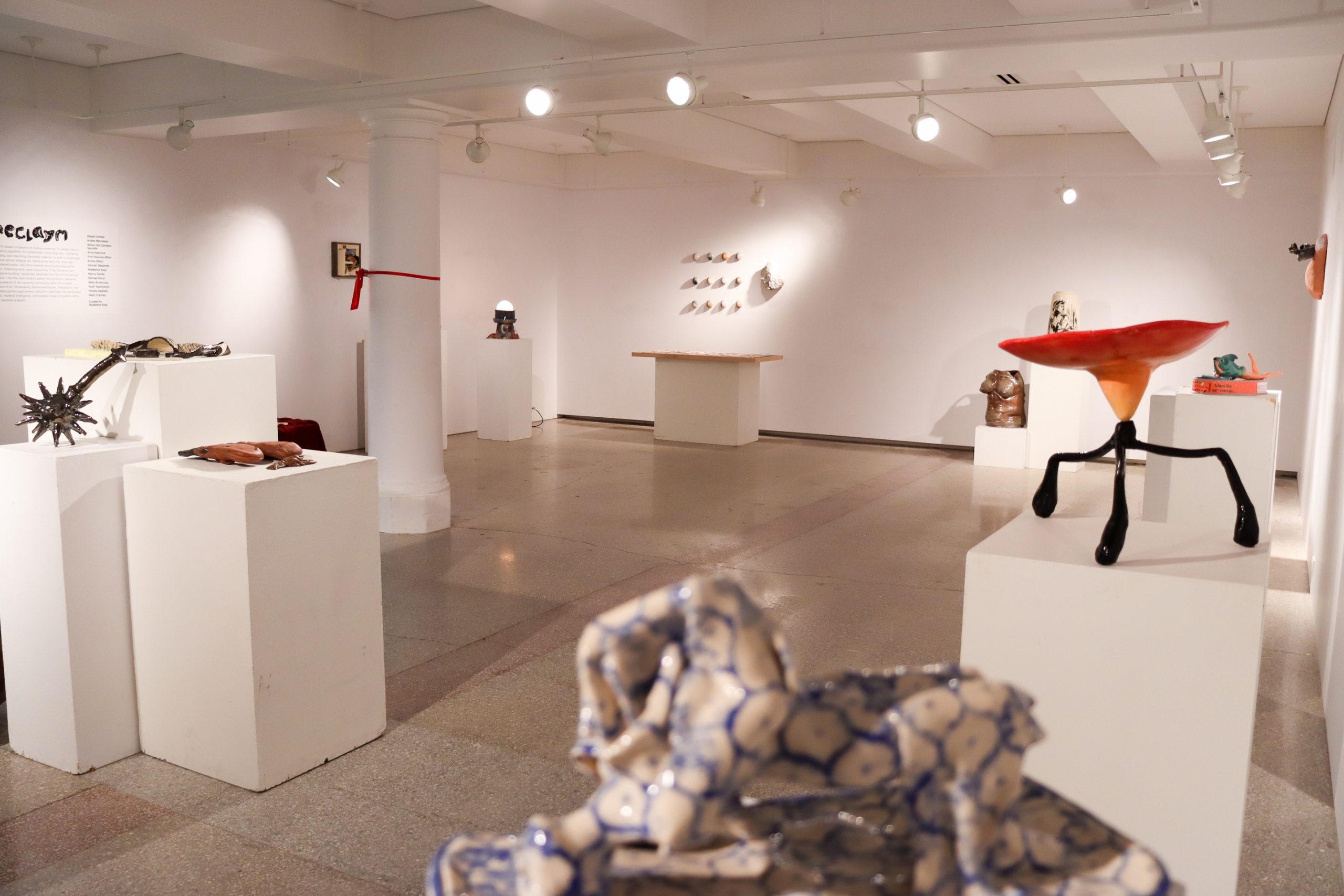 Installation view of the RECLAYM exhibition showing ceramic sculptures displayed on pedestals in the School of Art Student Gallery.