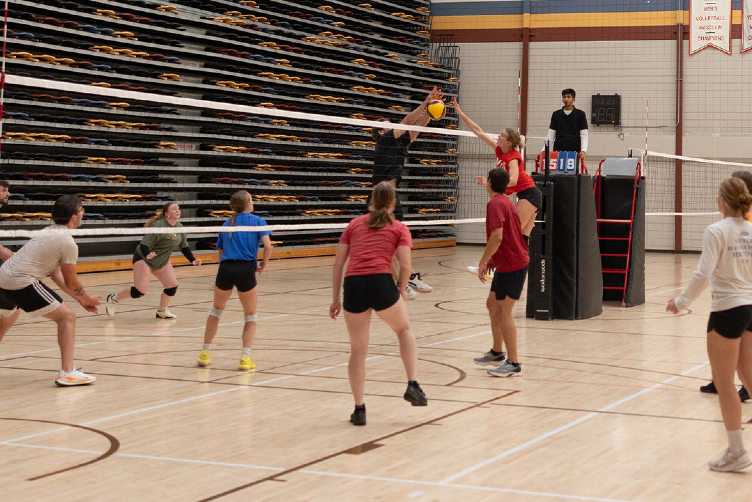 Two intramural volleyball teams facing off at the net
