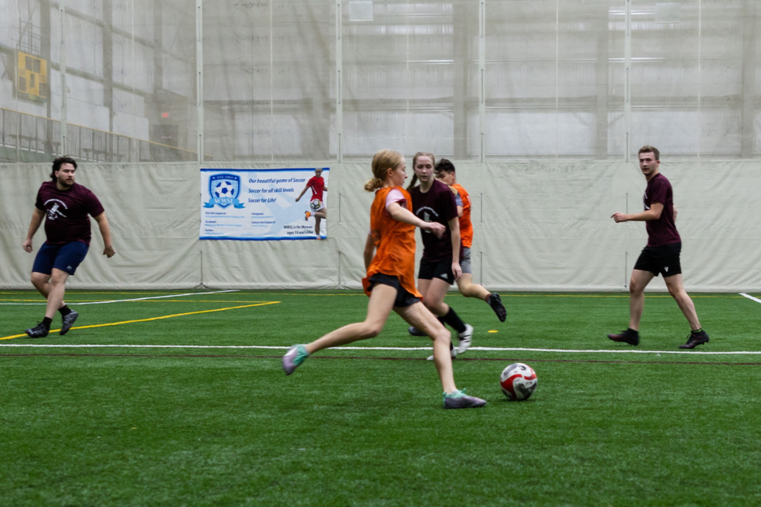 A soccer player kicking the ball during a game