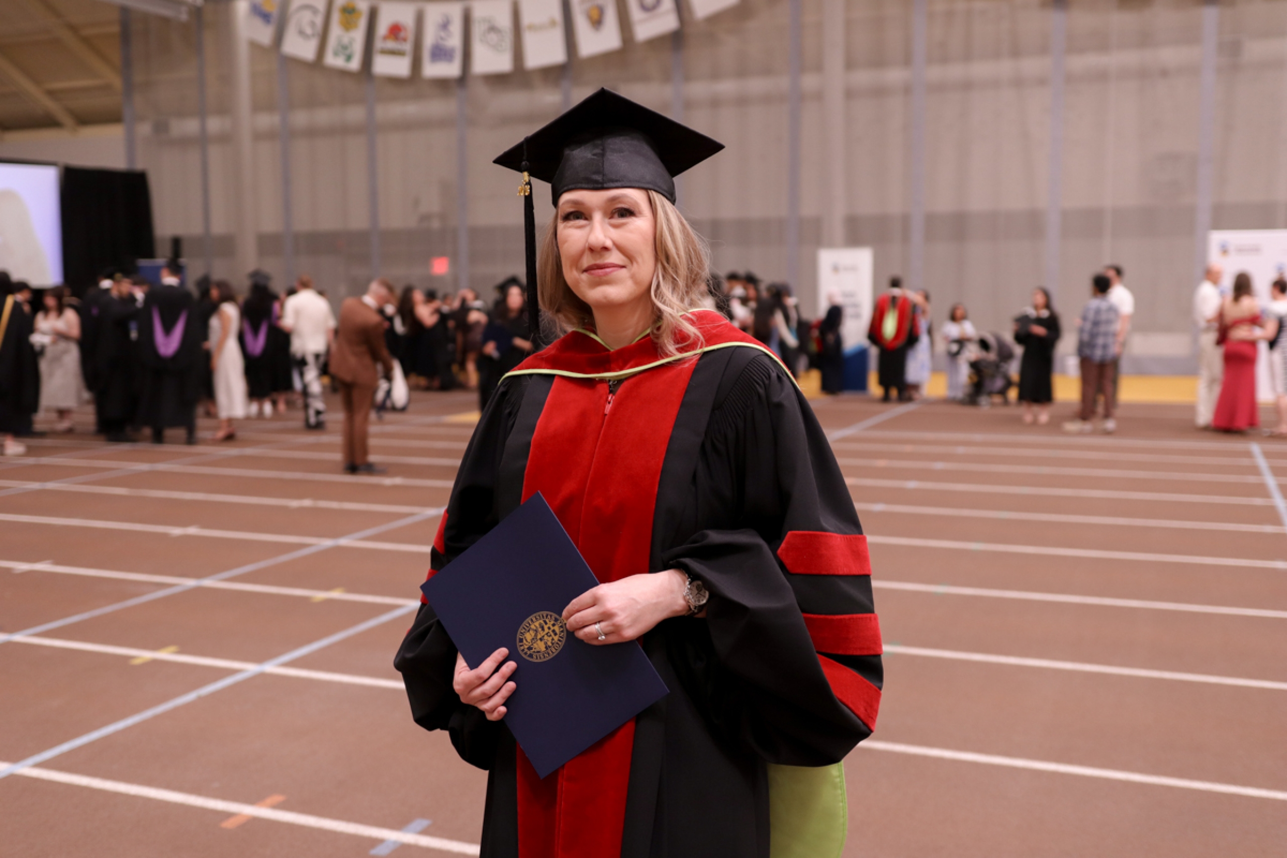 A student in graduation robes.